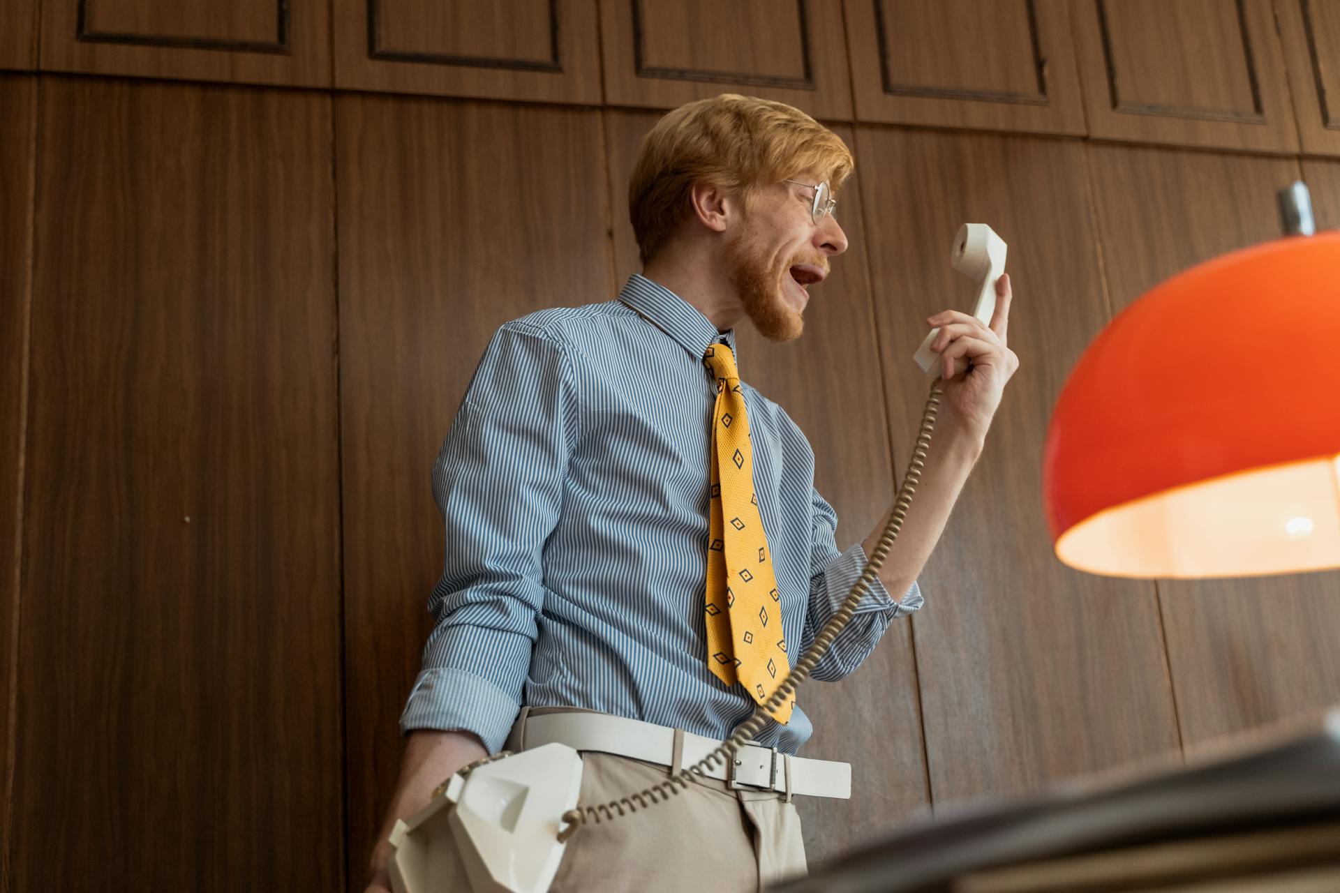 A man yelling while holding a telephone receiver | Source: Pexels