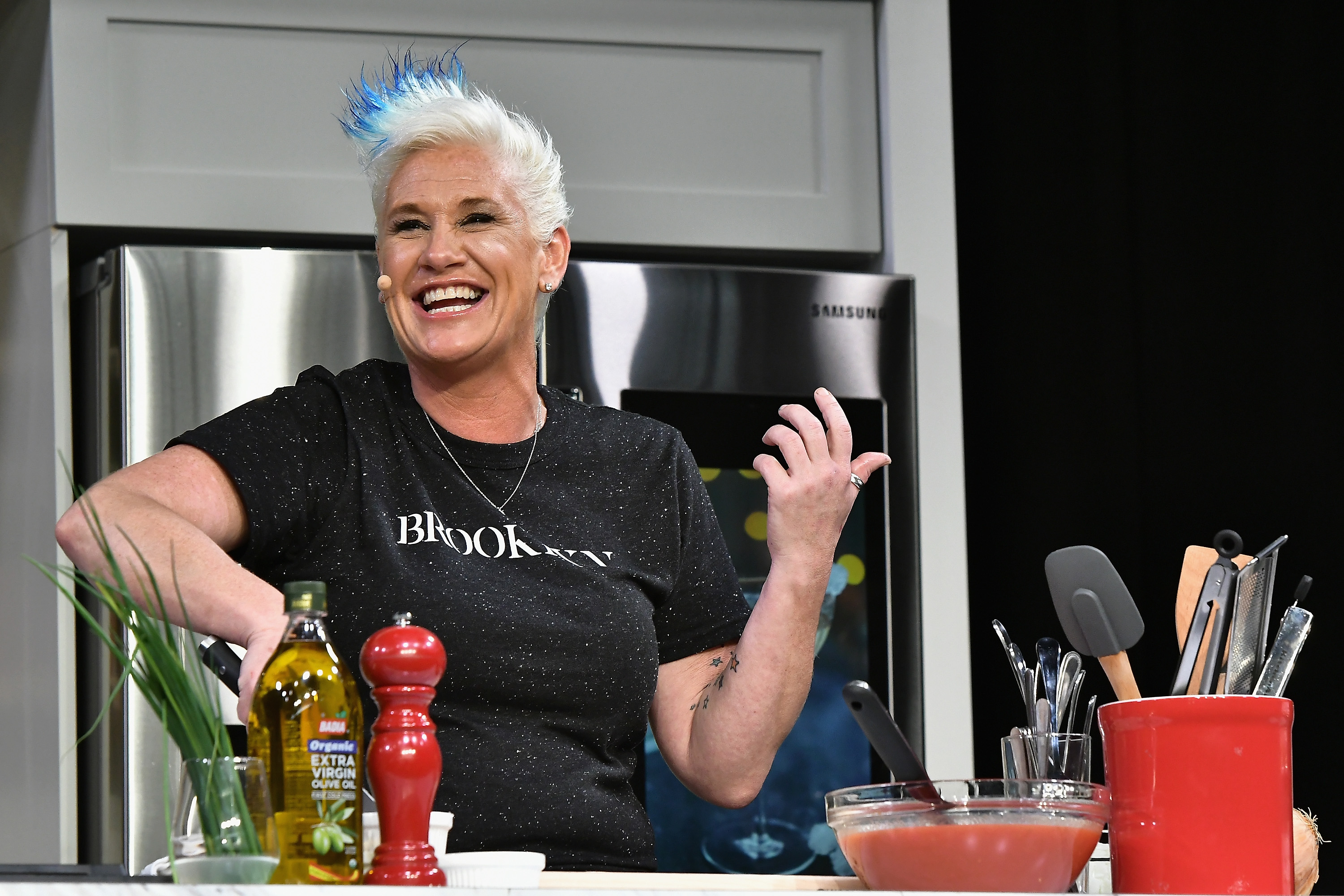 Chef Anne Burrell prepares a dish at the Food Network & Cooking Channel New York City Wine & Food Festival presented by Coca-Cola - Grand Tasting presented by ShopRite featuring Samsung® culinary demonstrations presented by Mastercard at Pier 94 on October 14, 2017, in New York City. | Source: Getty Images