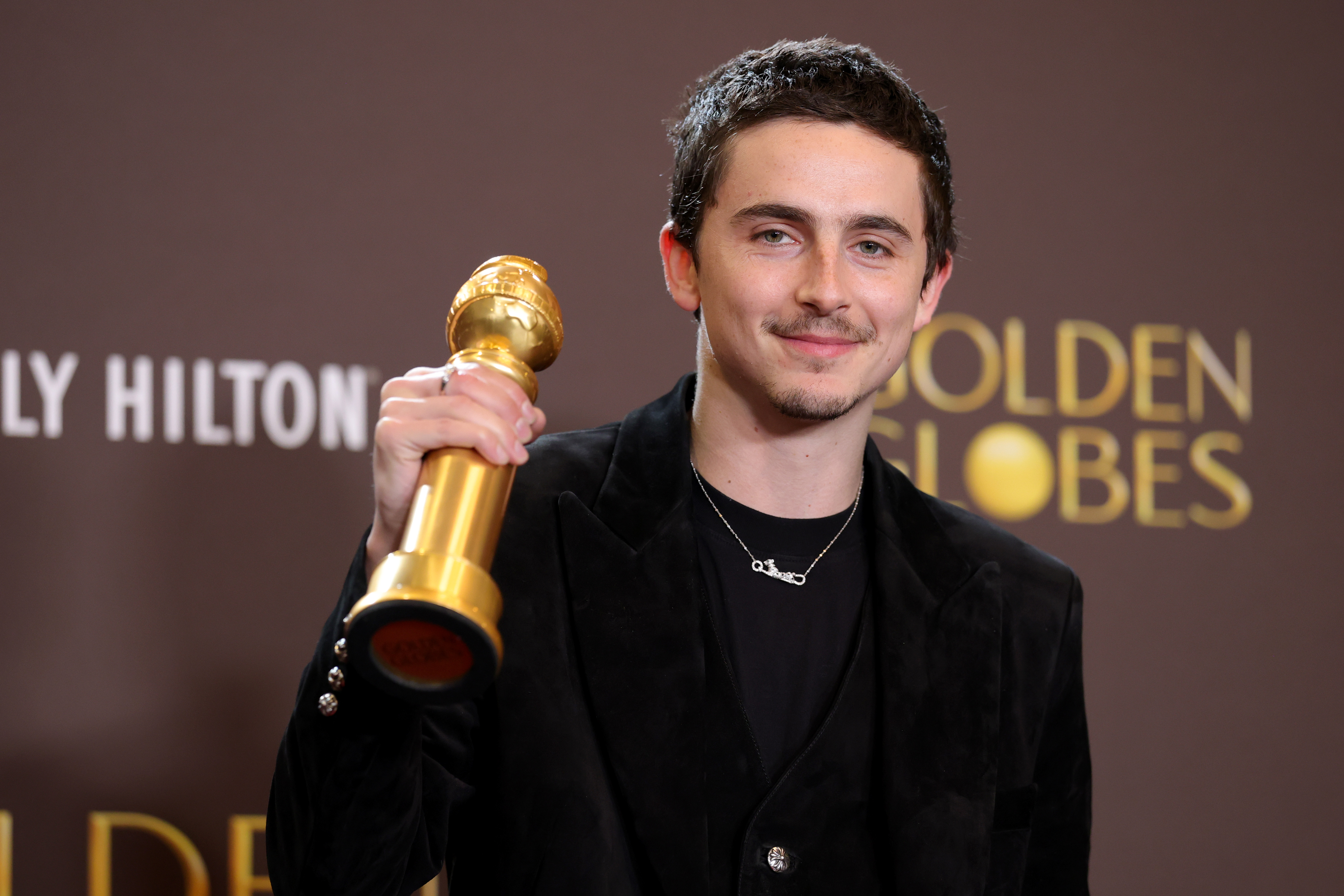 Timothée Chalamet with his trophy for Best Performance by a Male Actor in a Motion Picture – Musical or Comedy at the 83rd Annual Golden Globe Awards on January 11, 2026 | Source: Getty Images