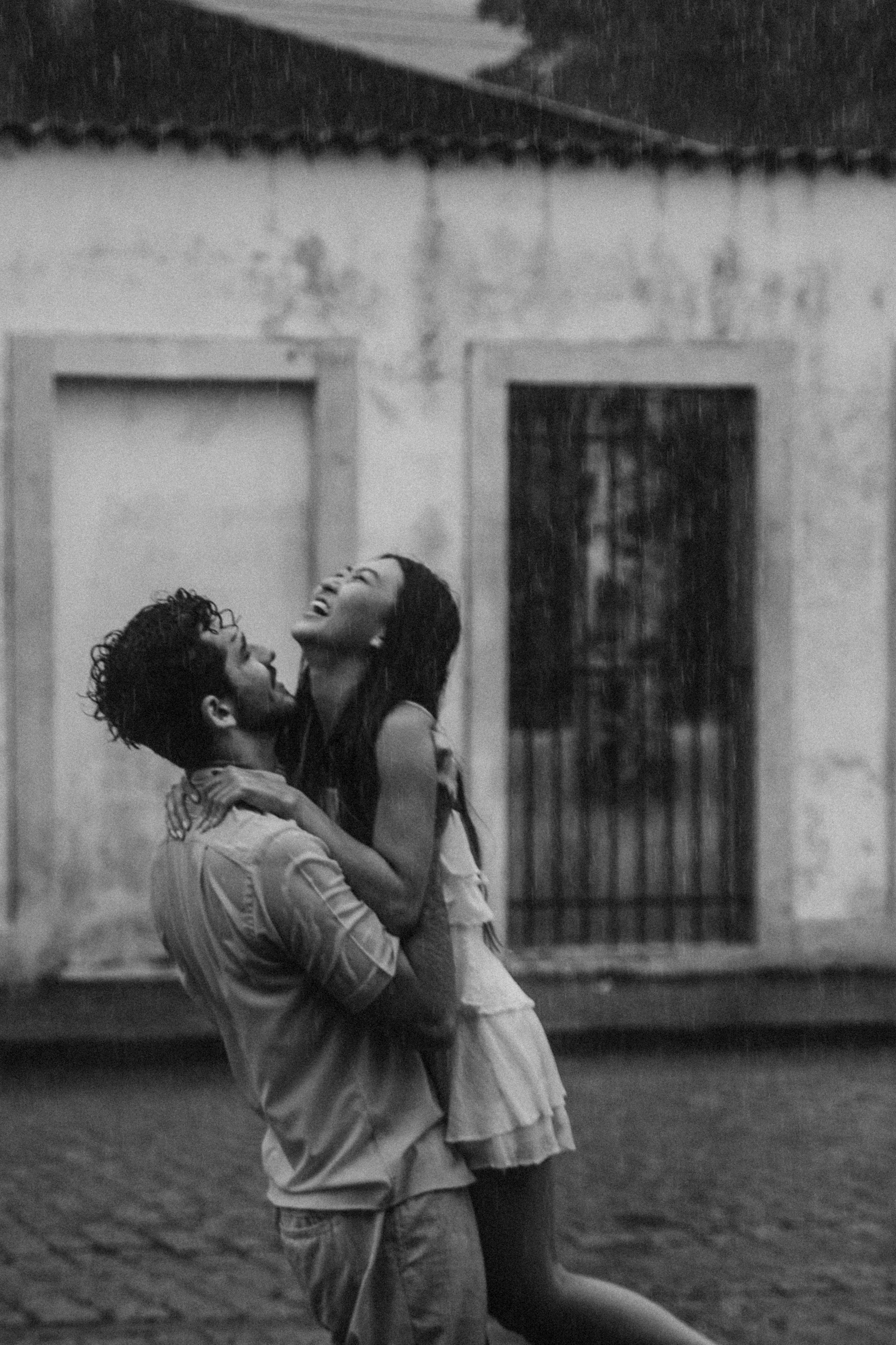 A happy couple standing in the rain | Source: Pexels