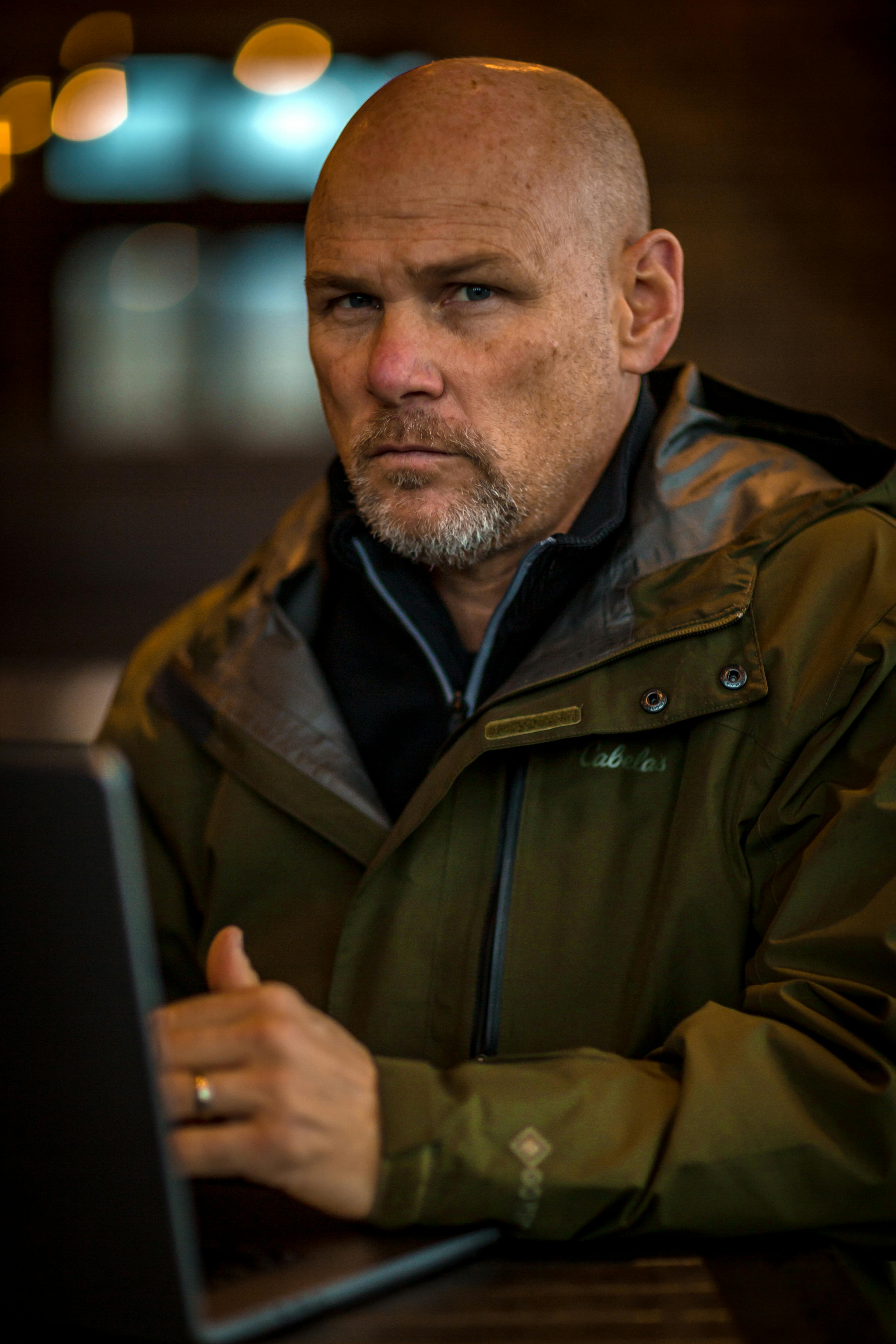 A stern man wearing a green jacket | Source: Pexels