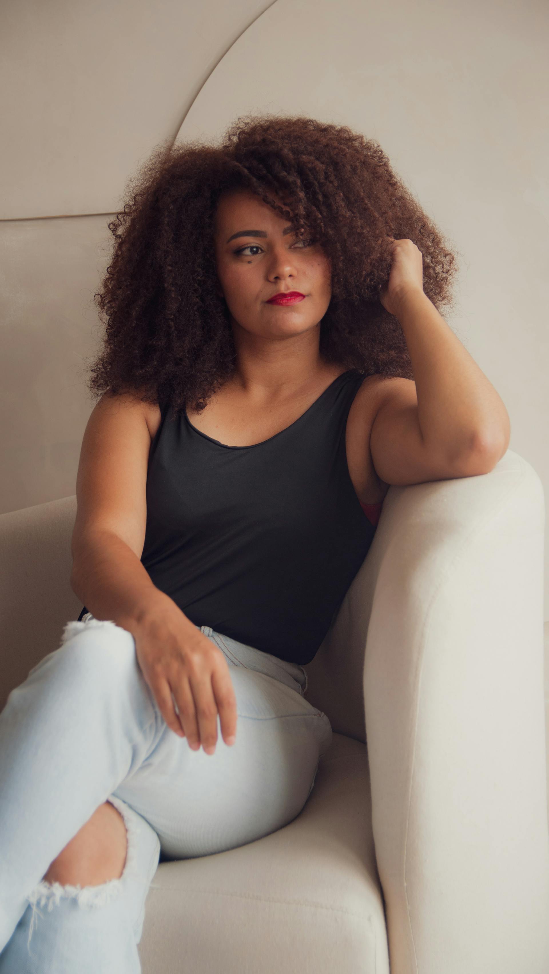 A thoughtful woman on a sofa | Source: Pexels