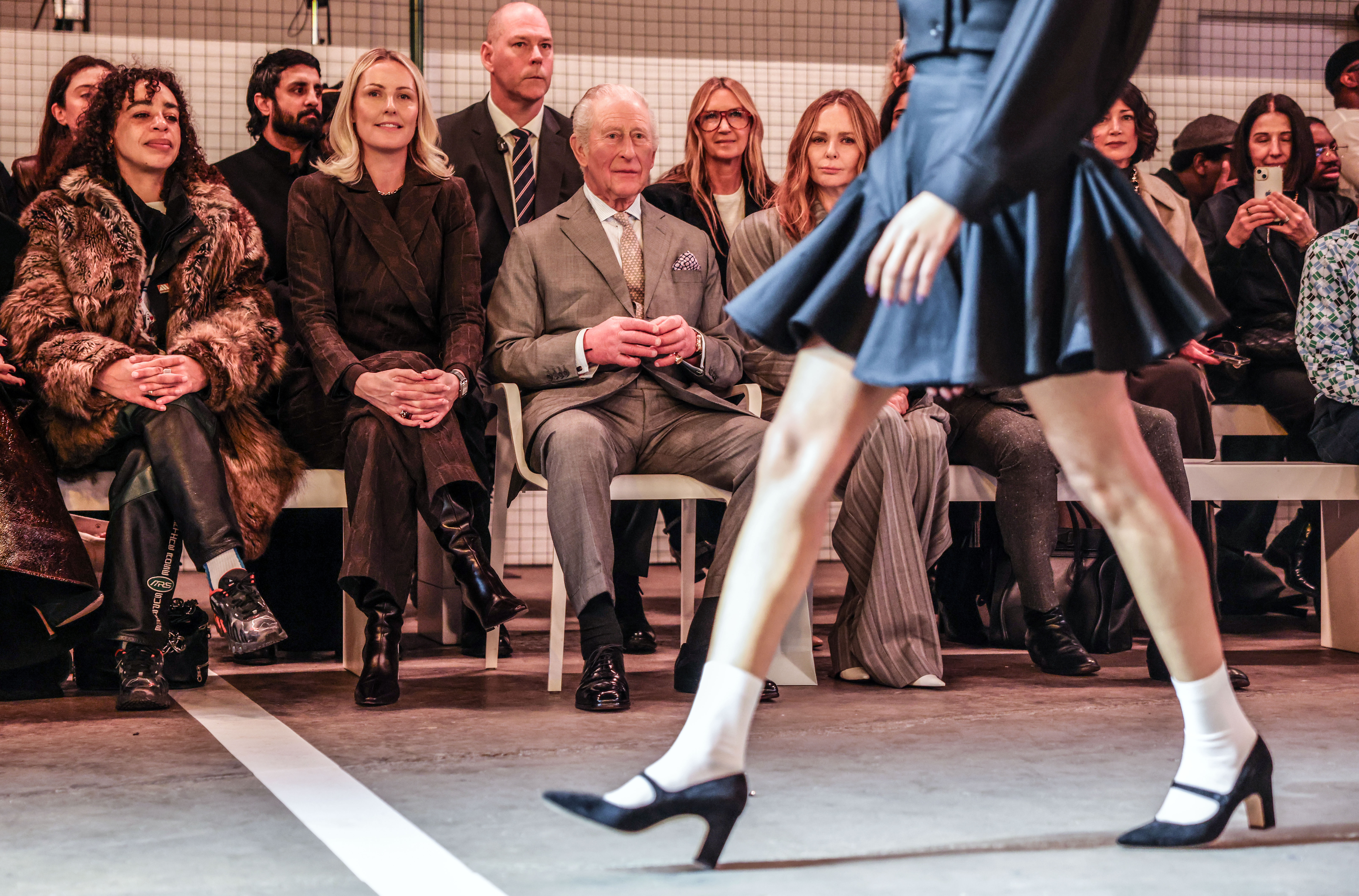 King Charles III at the front row of Tolu Coker's show at London Fashion Week on February 19, 2023 | Source: Getty Images