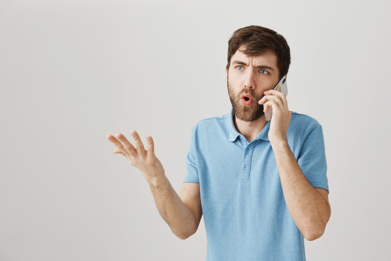 An annoyed man talking on the phone | Source: Freepik