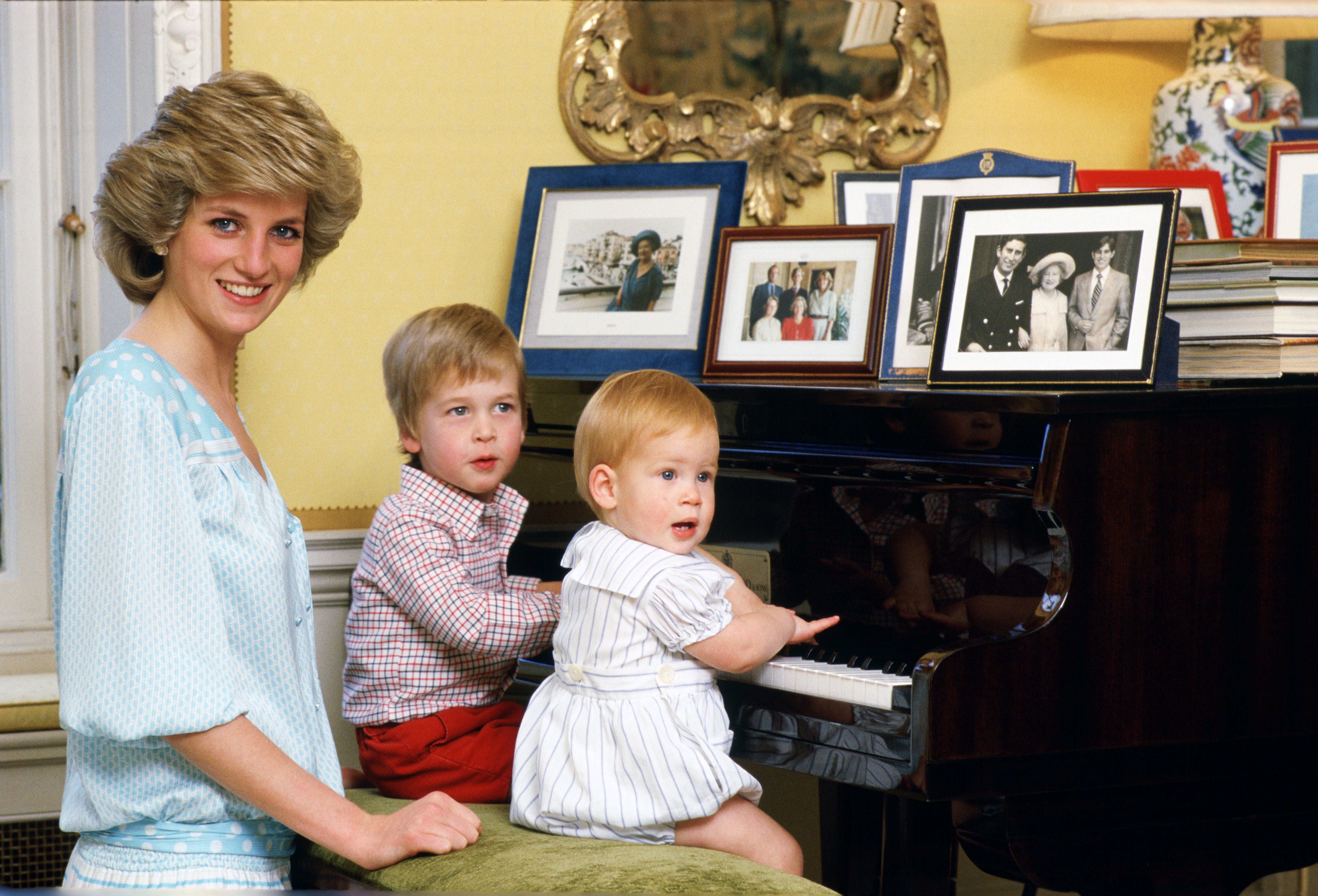 Diana, Princess of Wales with her sons, Prince William and Prince Harry, at the piano in Kensington Palace on October 4, 1985. | Source: Getty Images
