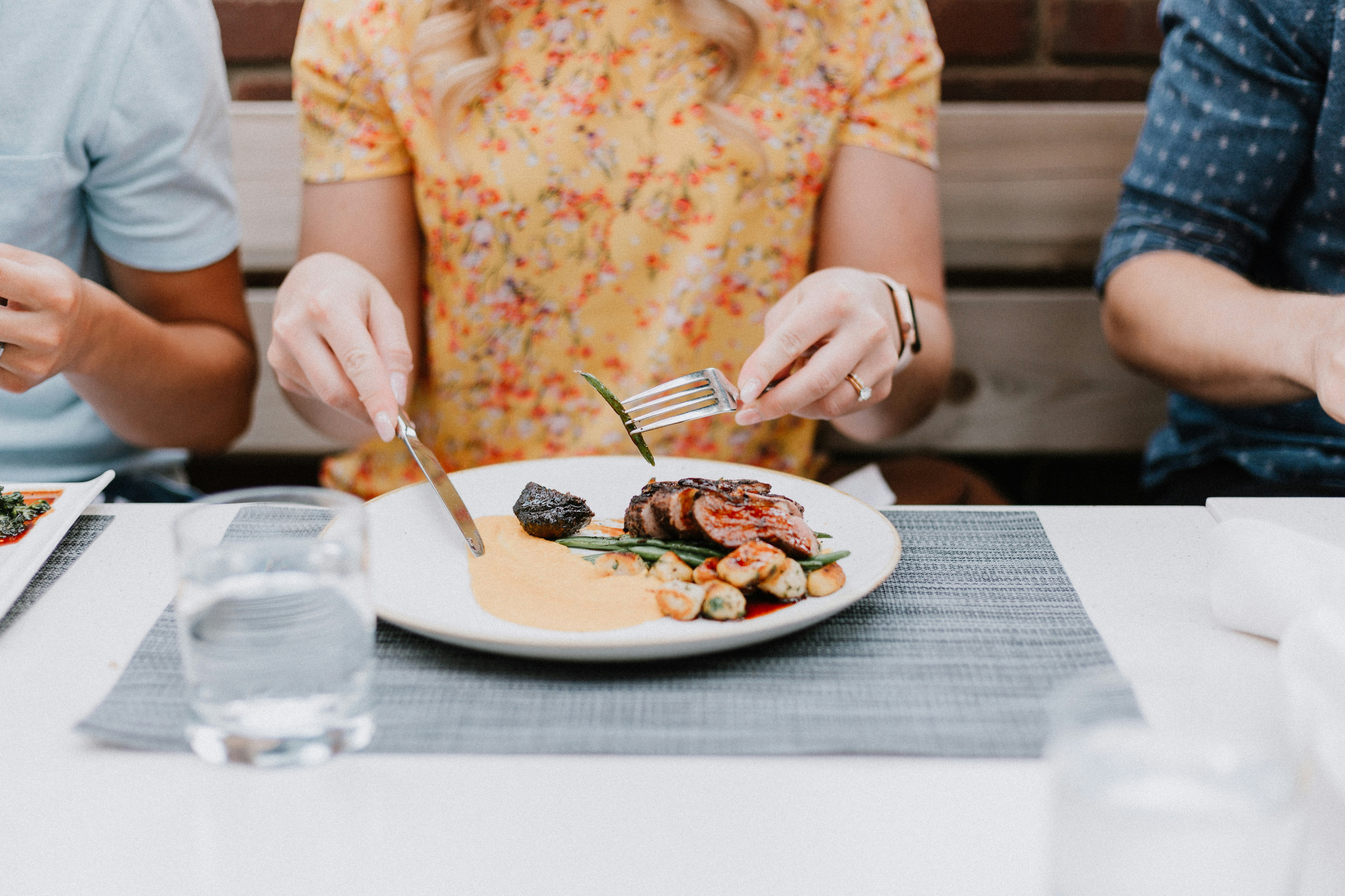 A person sitting at a restaurant table | Source: Unsplash