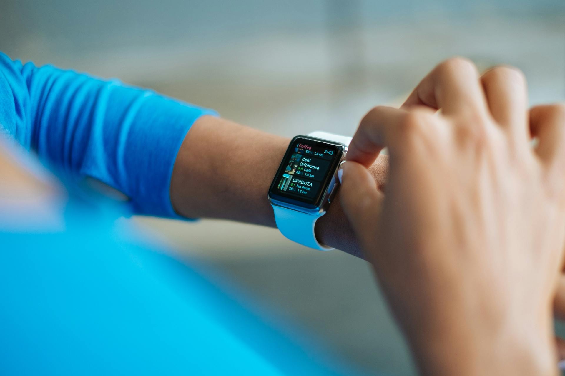 A woman using her smartwatch | Source: Pexels