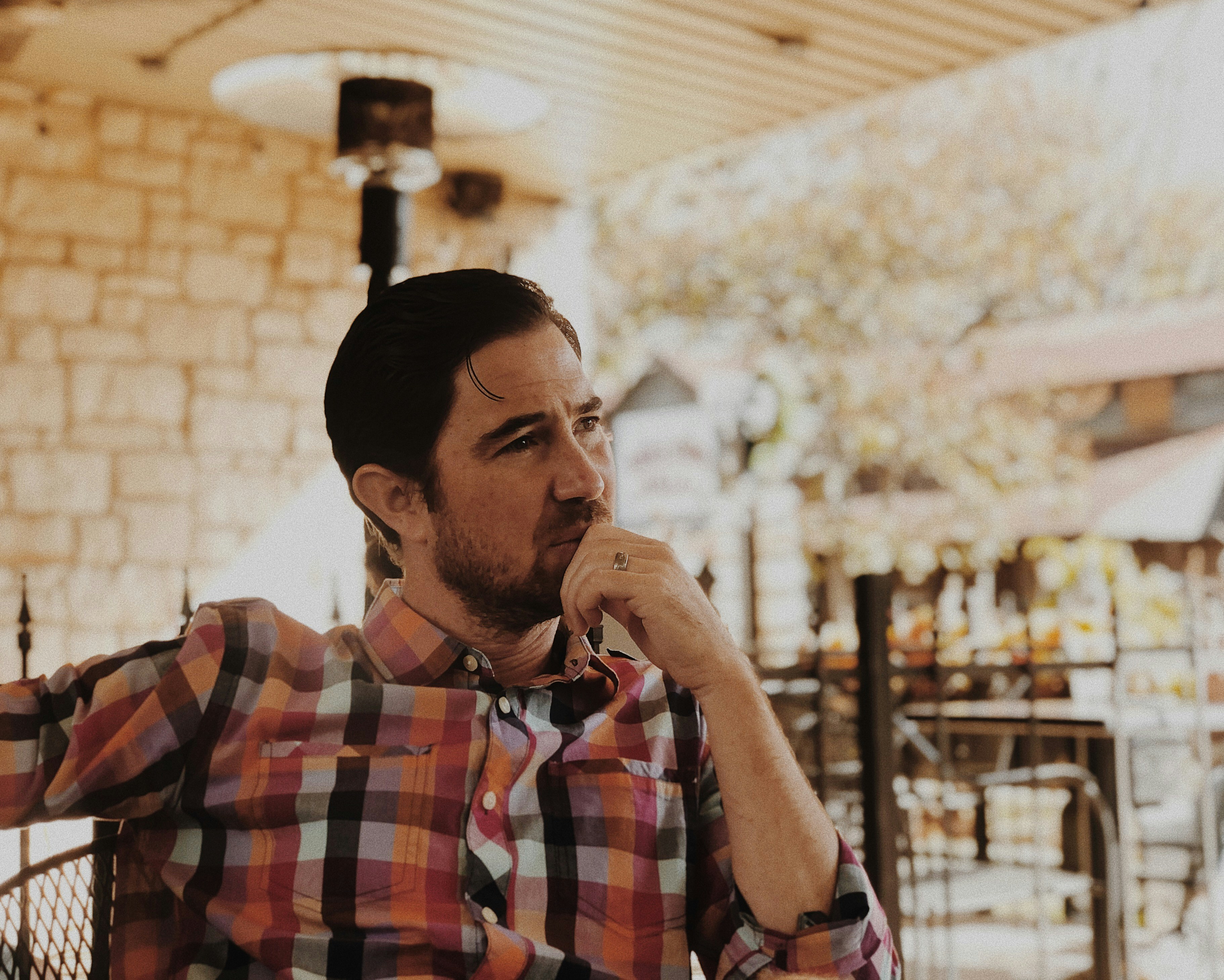 An emotional man sitting at a table | Source: Unsplash