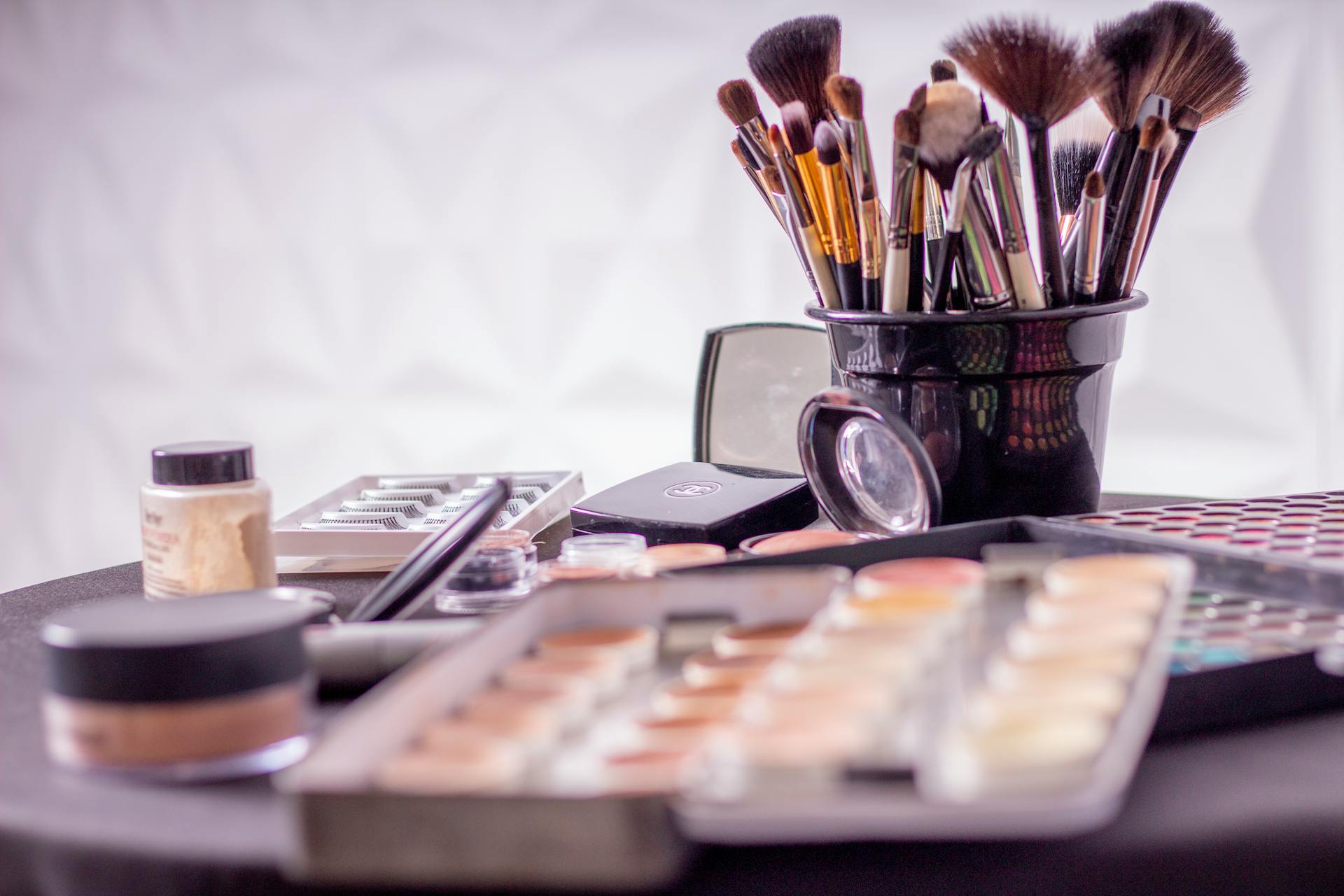 Makeup brushes and makeup products on a table | Source: Pexels