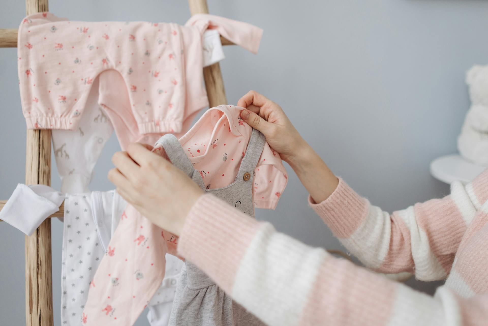 A woman holding baby clothing | Source: Pexels