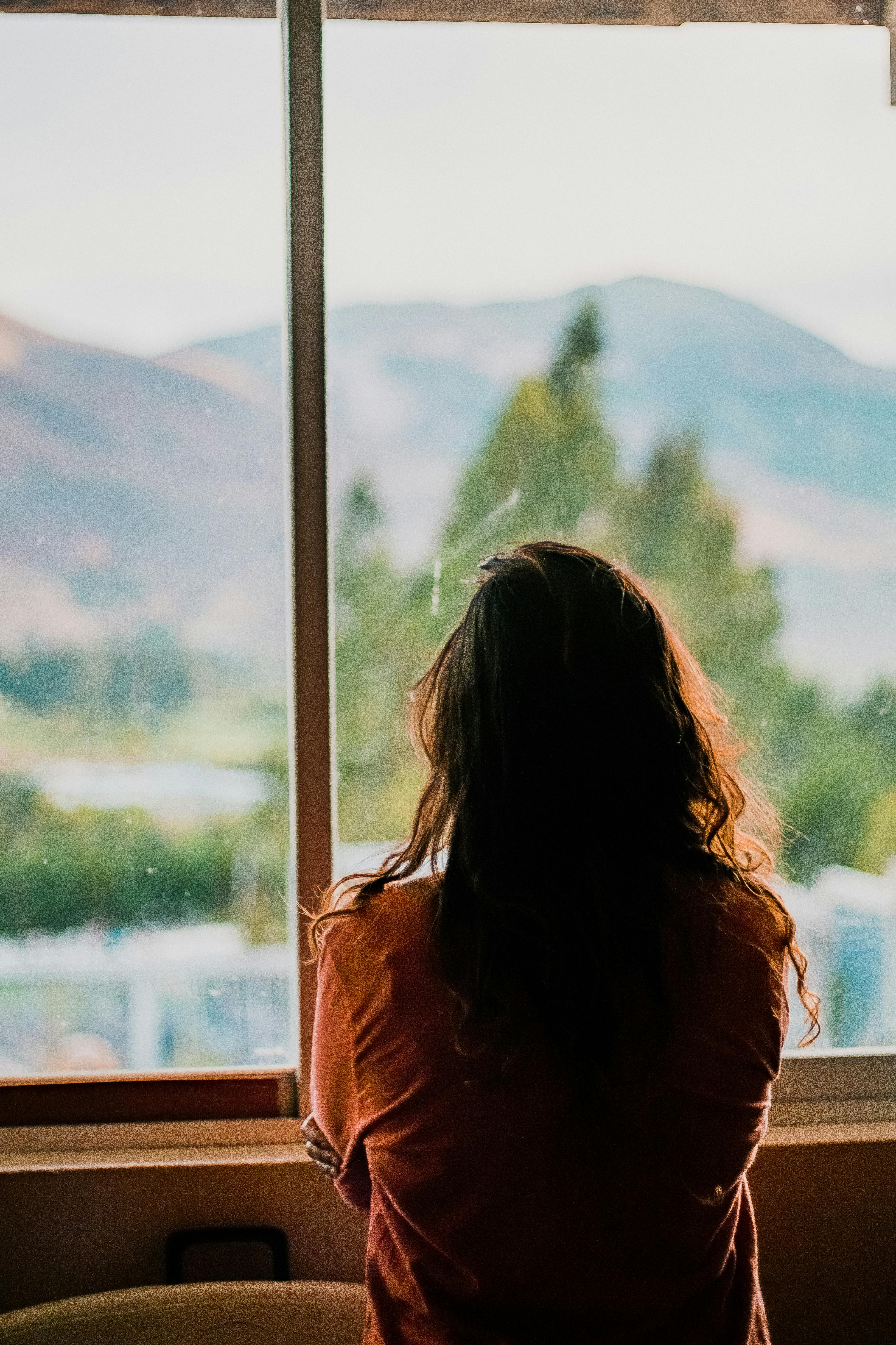 A withdrawn woman looking outside | Source: Pexels