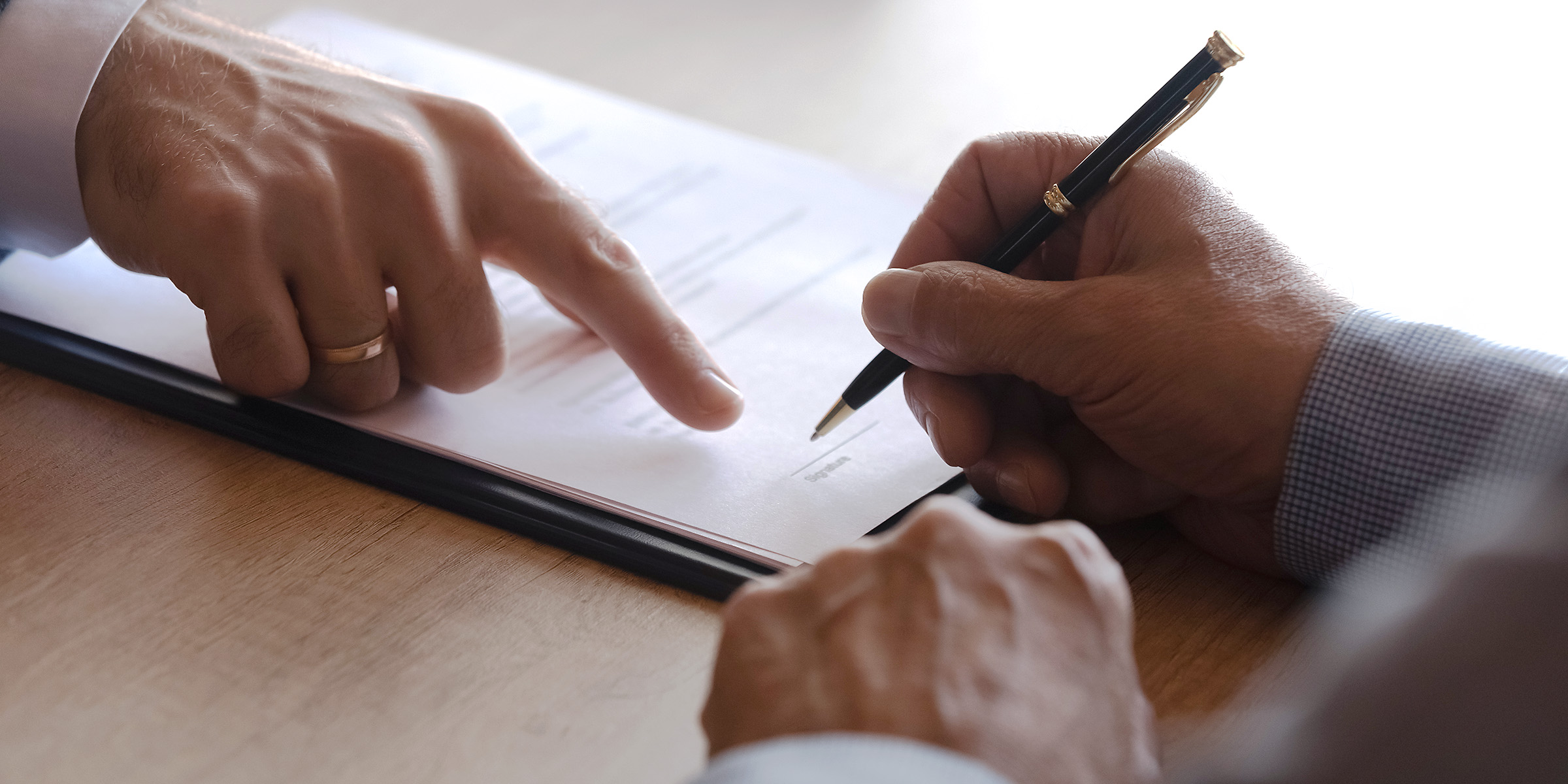 Someone signing paperwork | Source: Shutterstock