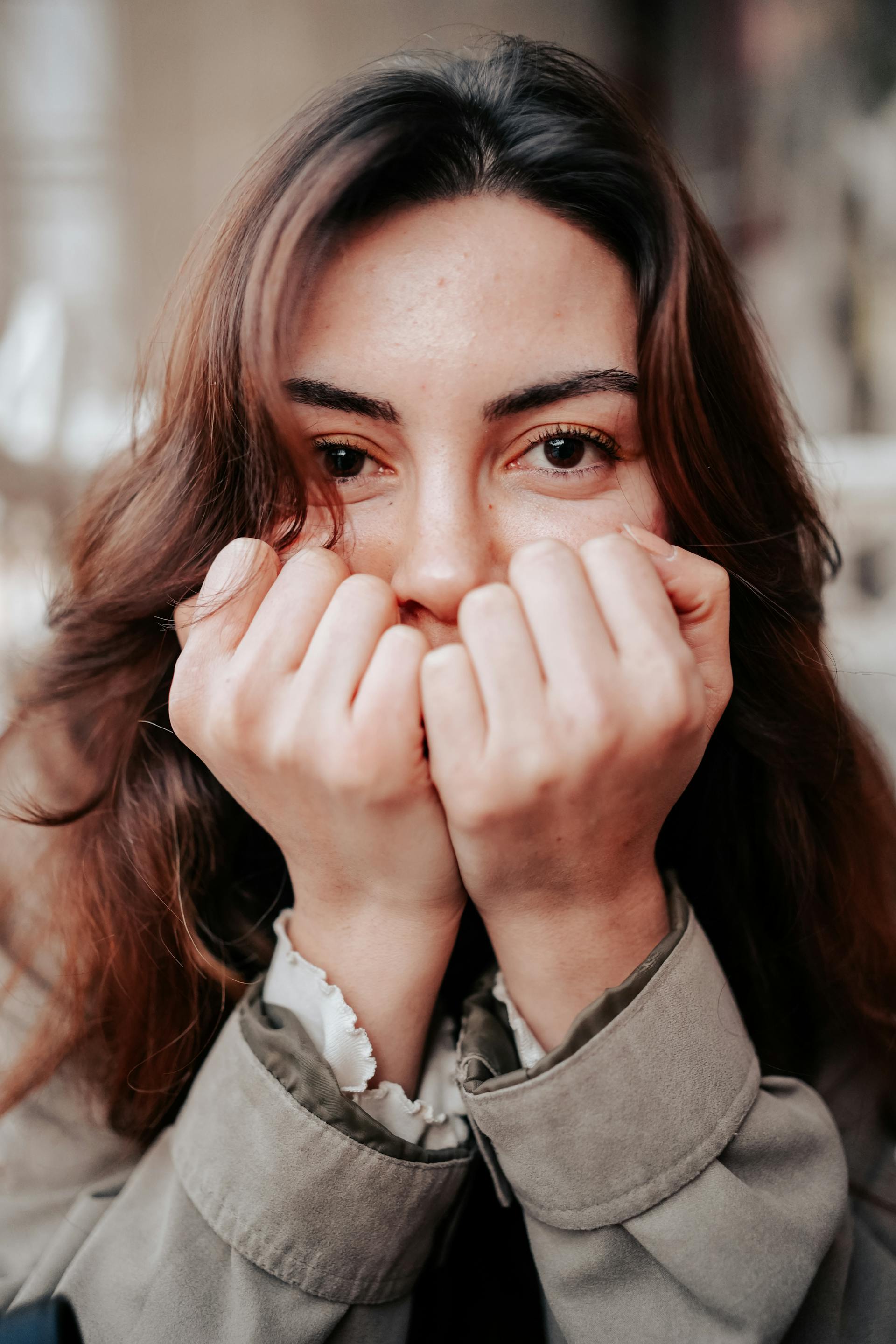 A woman covering her face with her hands | Source: Pexels