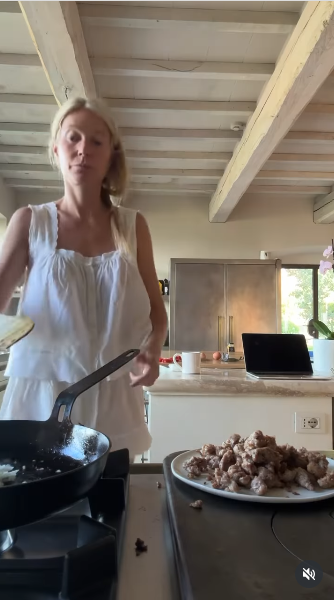 Gwyneth Paltrow, dressed in an all-white ensemble, prepares breakfast in a bright, sun-drenched kitchen, moving with quiet confidence from a video posted on June 14, 2025 | Source: Instagram/gwynethpaltrow