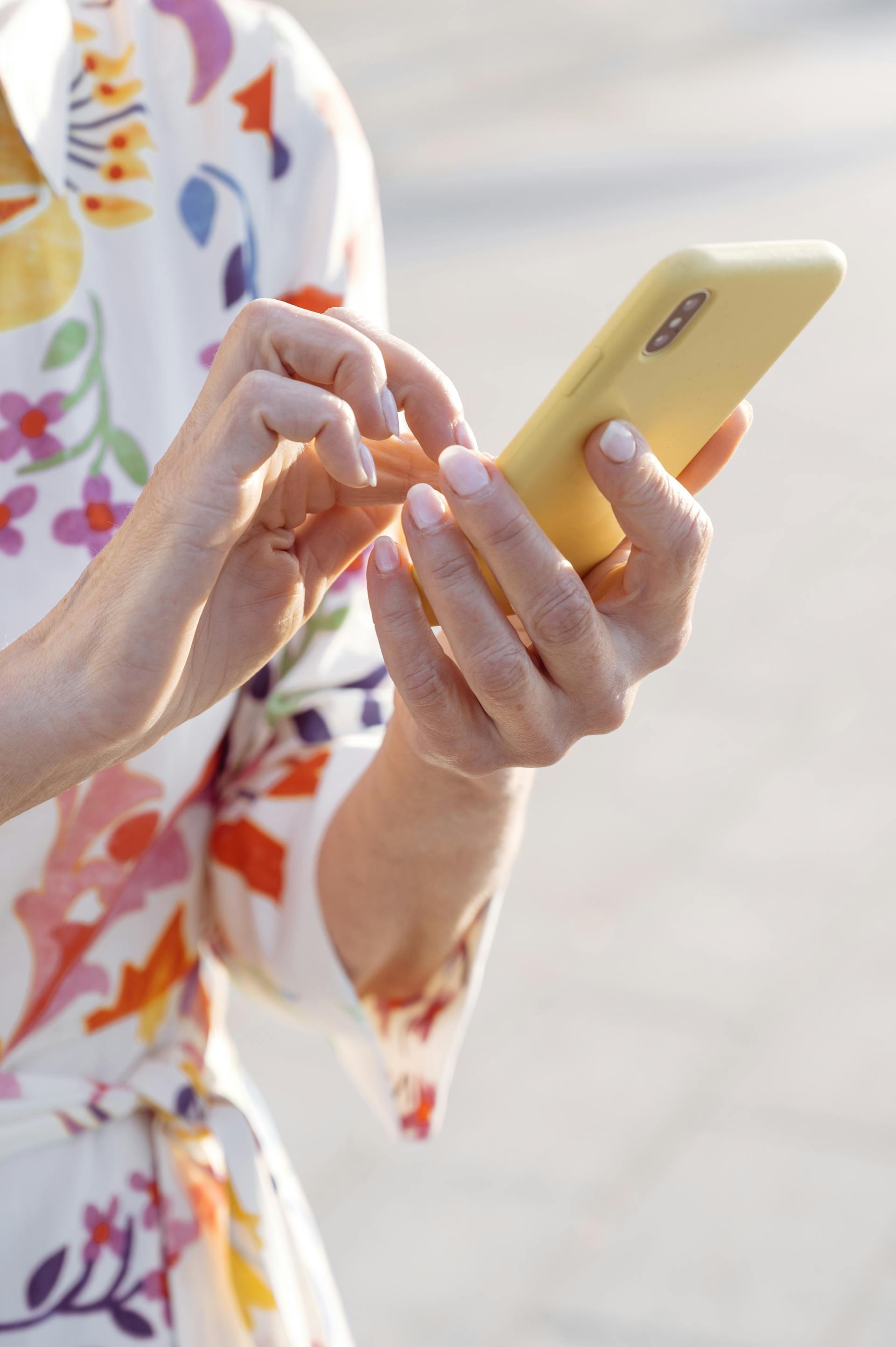 A woman holding a cell phone | Source: Midjourney