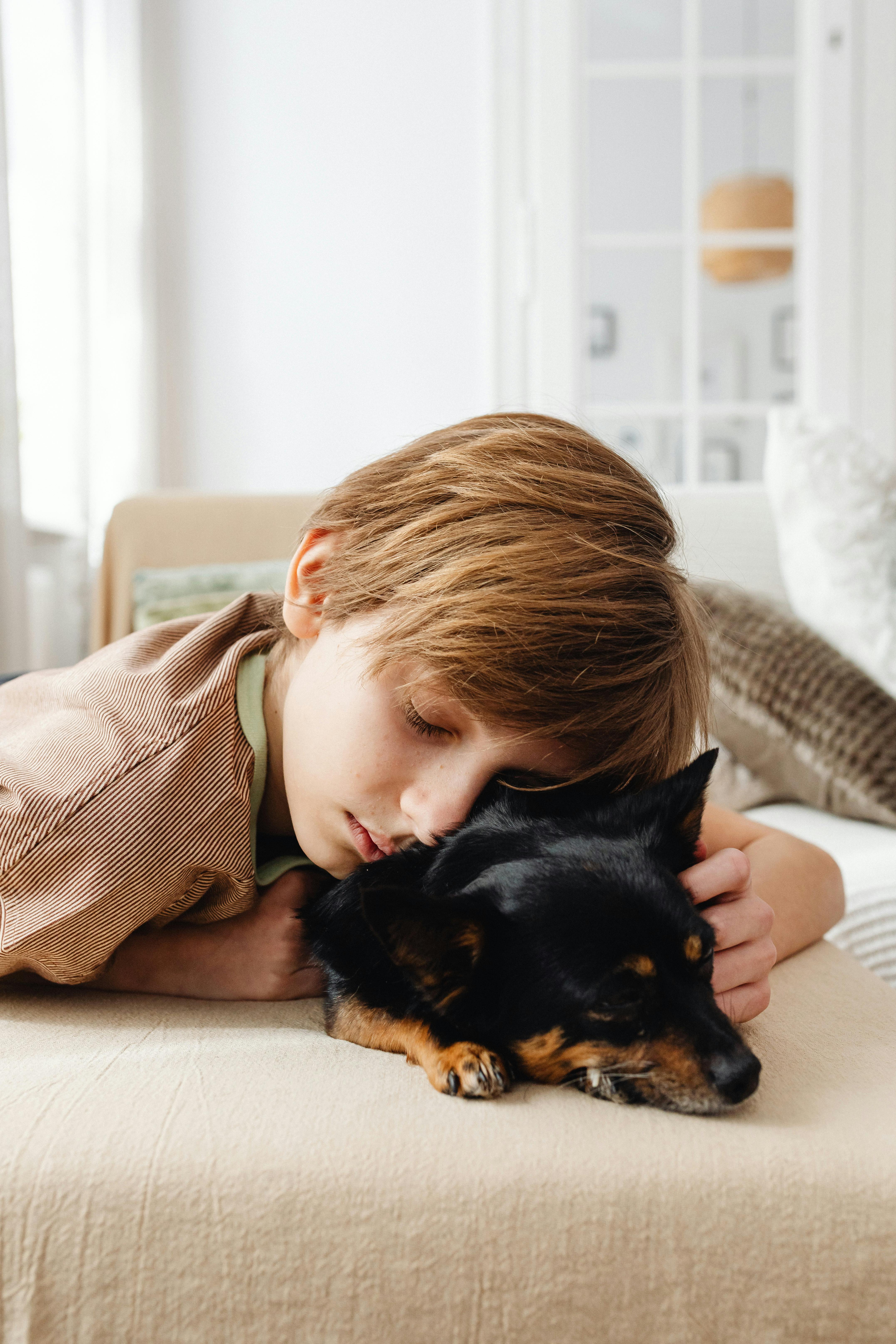A sleeping little boy and dog | Source: Pexels