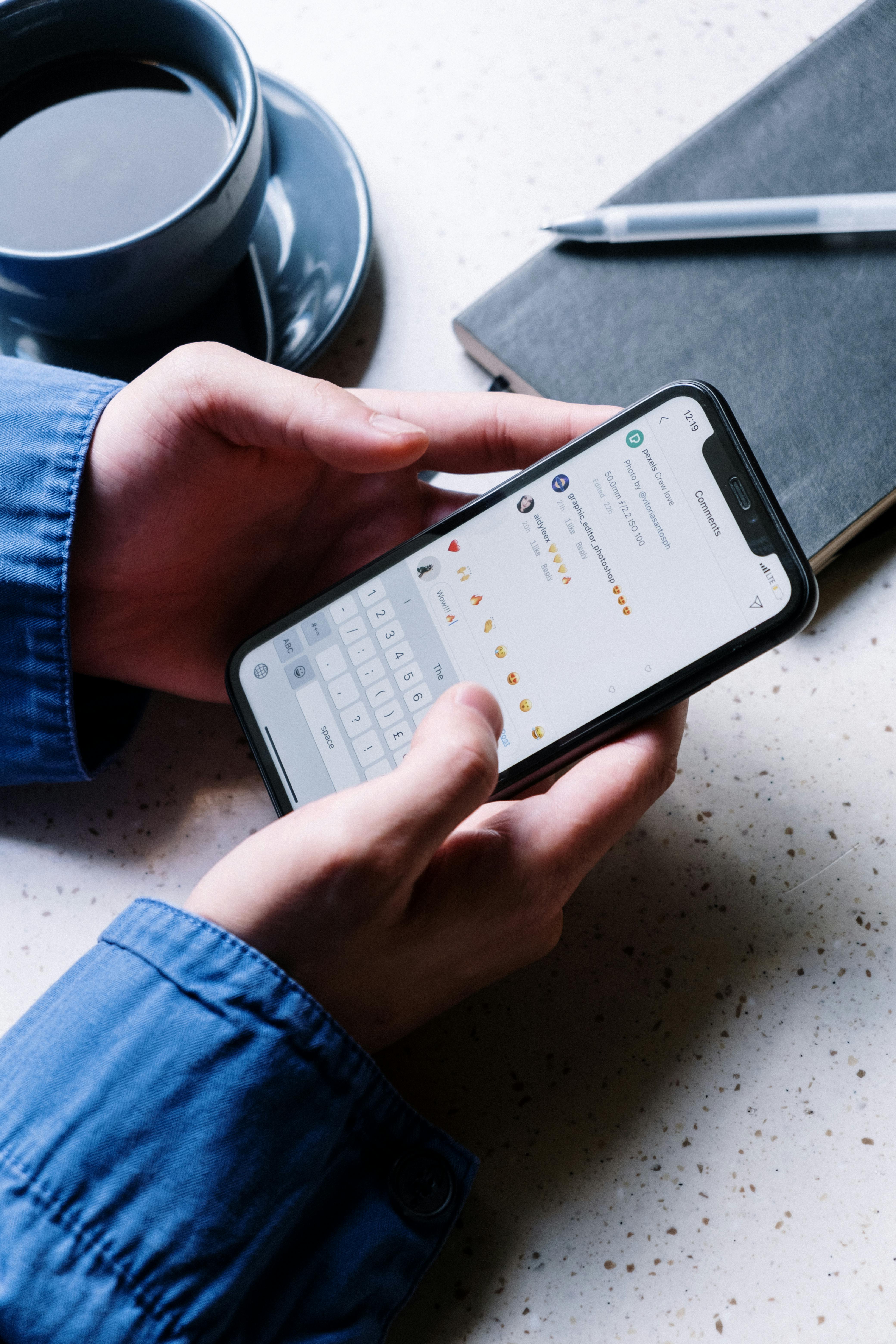 A person holding a phone open to social media comments | Source: Pexels