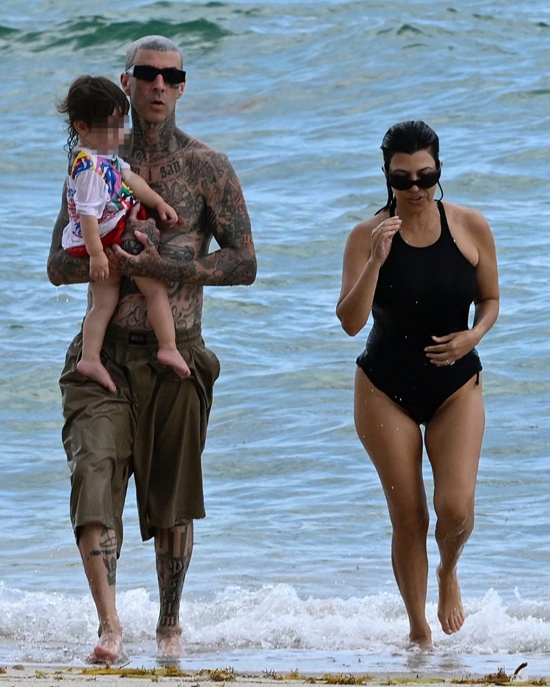 Kourtney Kardashion is seen with her husband, Travis Barker, and their son at the beach in Miami on Wednesday, August 27, 2025. | Source: Instagram/pagesix