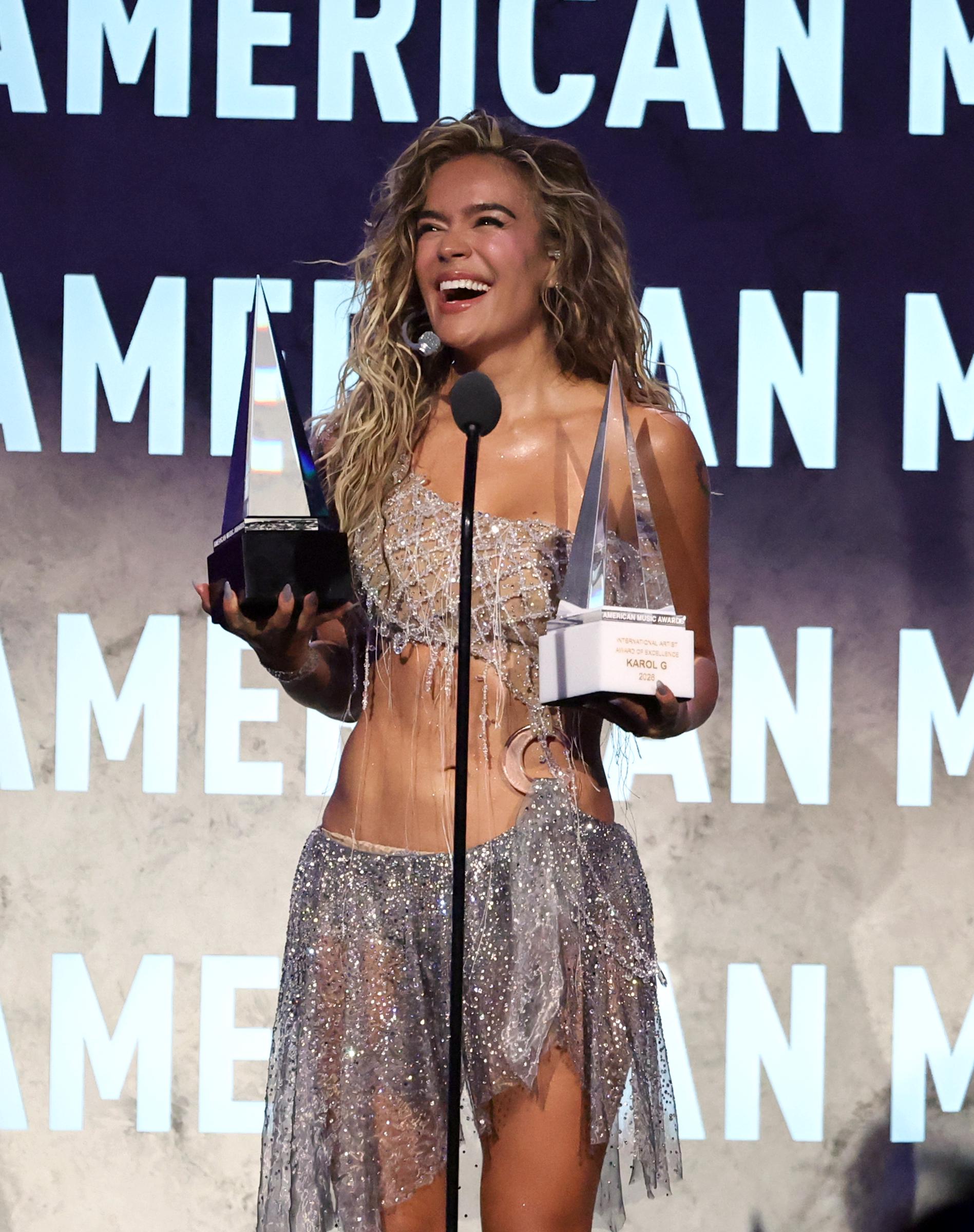 Karol G, winner of the Best Latin Album award for "Tropicoqueta," accepts the International Artist Award of Excellence onstage during the 52nd American Music Awards at MGM Grand Garden Arena on May 25, 2026, in Las Vegas, Nevada. | Source: Getty Images