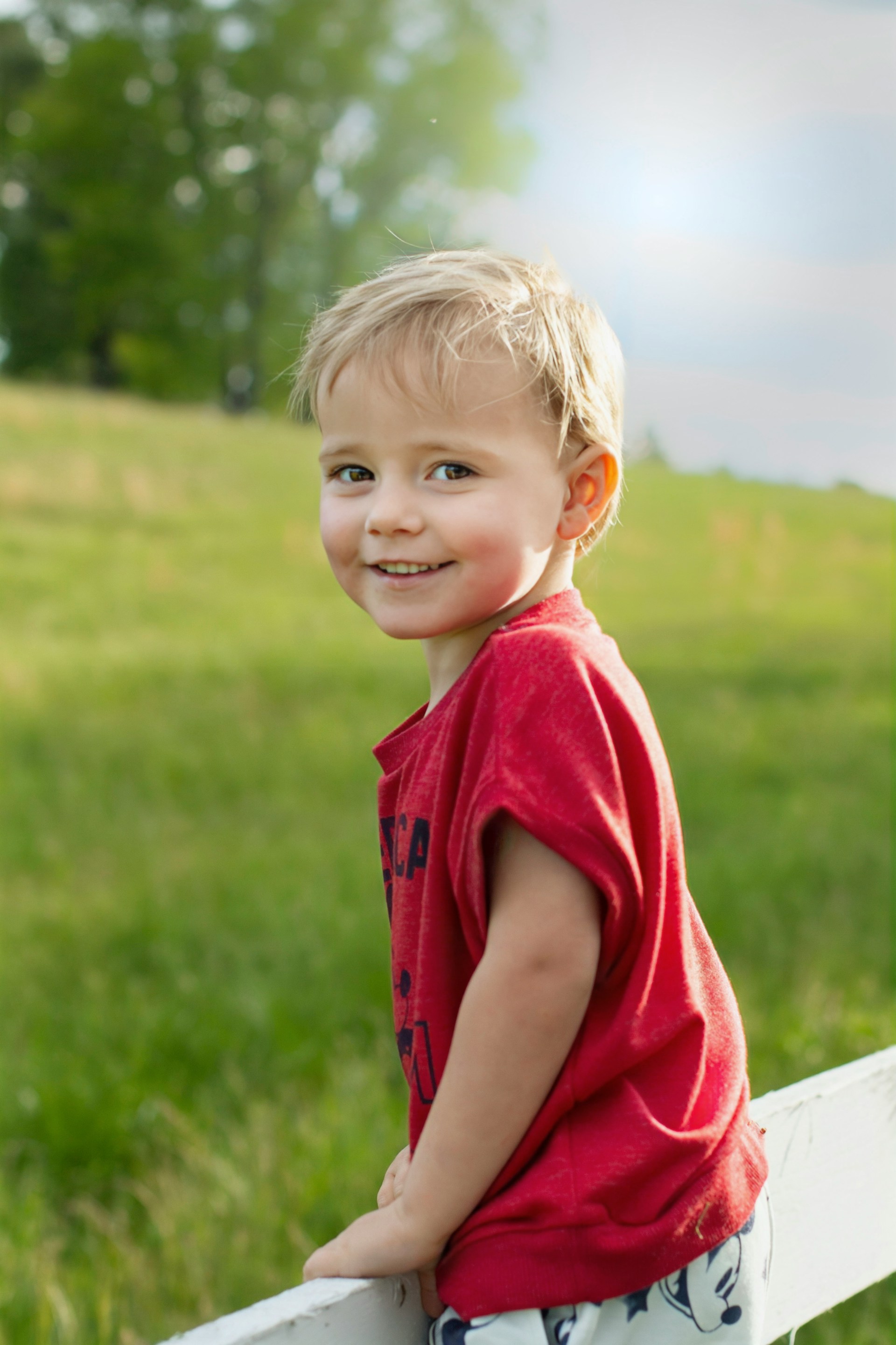 A happy little boy standing outdoors | Source: Unsplash