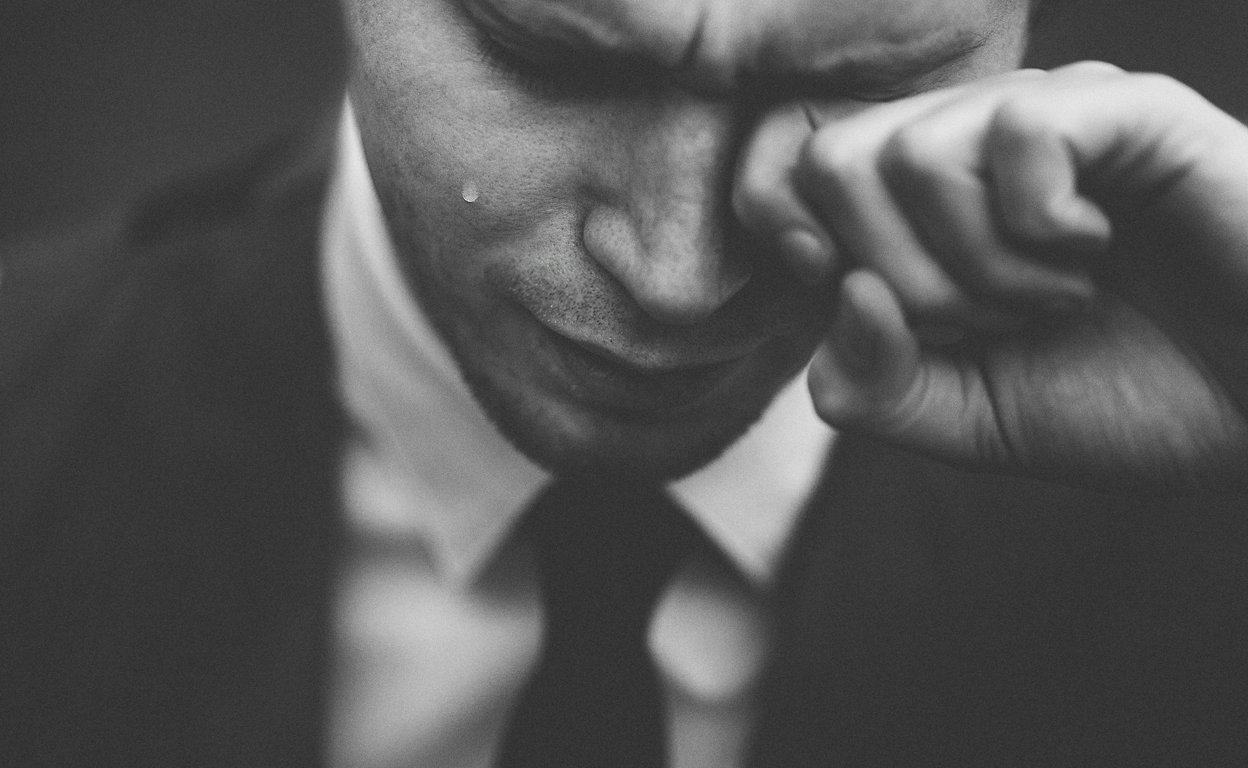 A man wiping away tears | Source: Unsplash