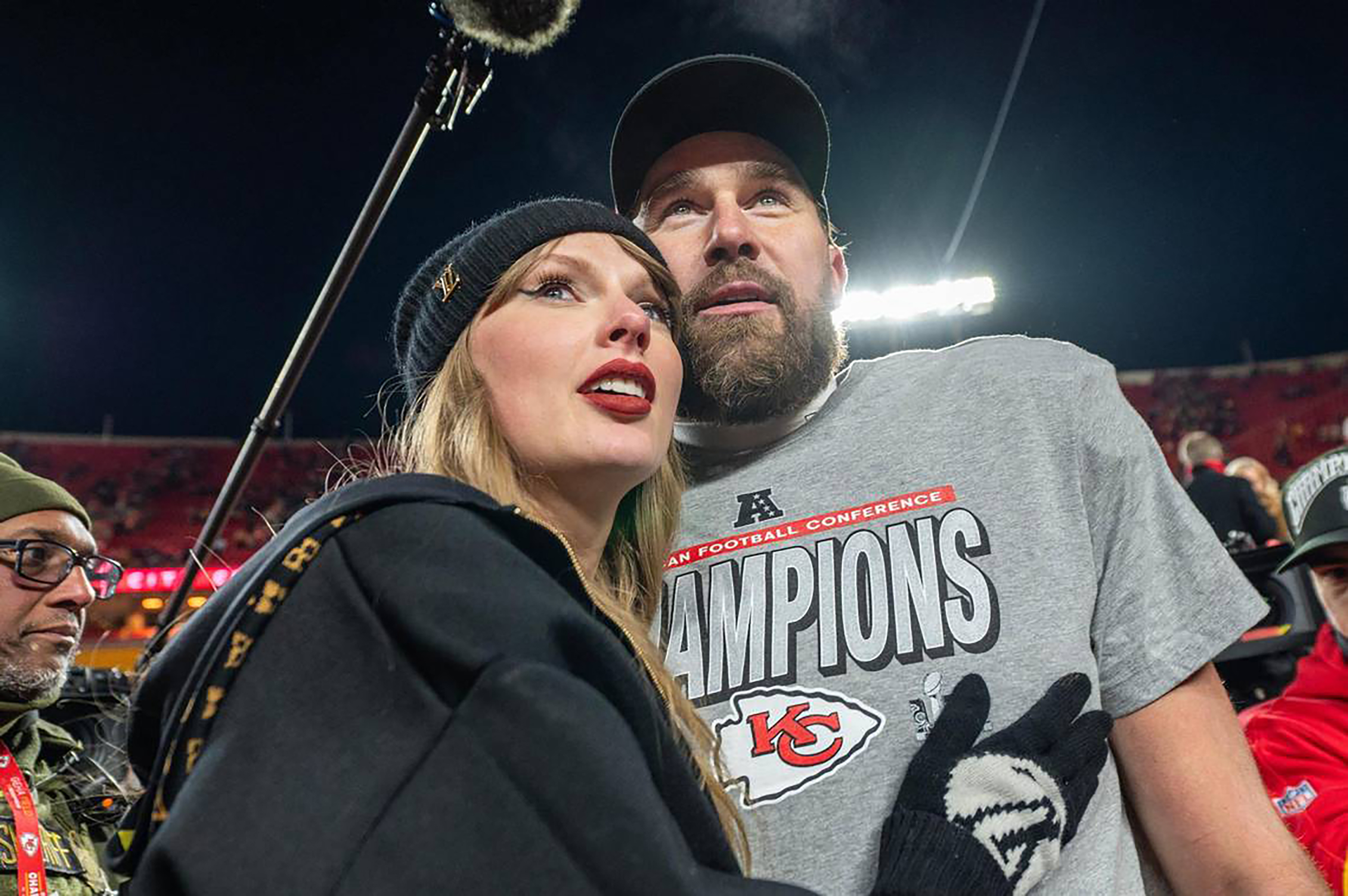 Taylor Swift and Kansas City Chiefs tight end Travis Kelce (87) walk off the field after the trophy ceremony following the Chiefs 32-29 victory over the Buffalo Bills in the AFC Championship Game on Sunday, Jan. 26, 2025, at GEHA Field at Arrowhead Stadium. | Source: Getty Images