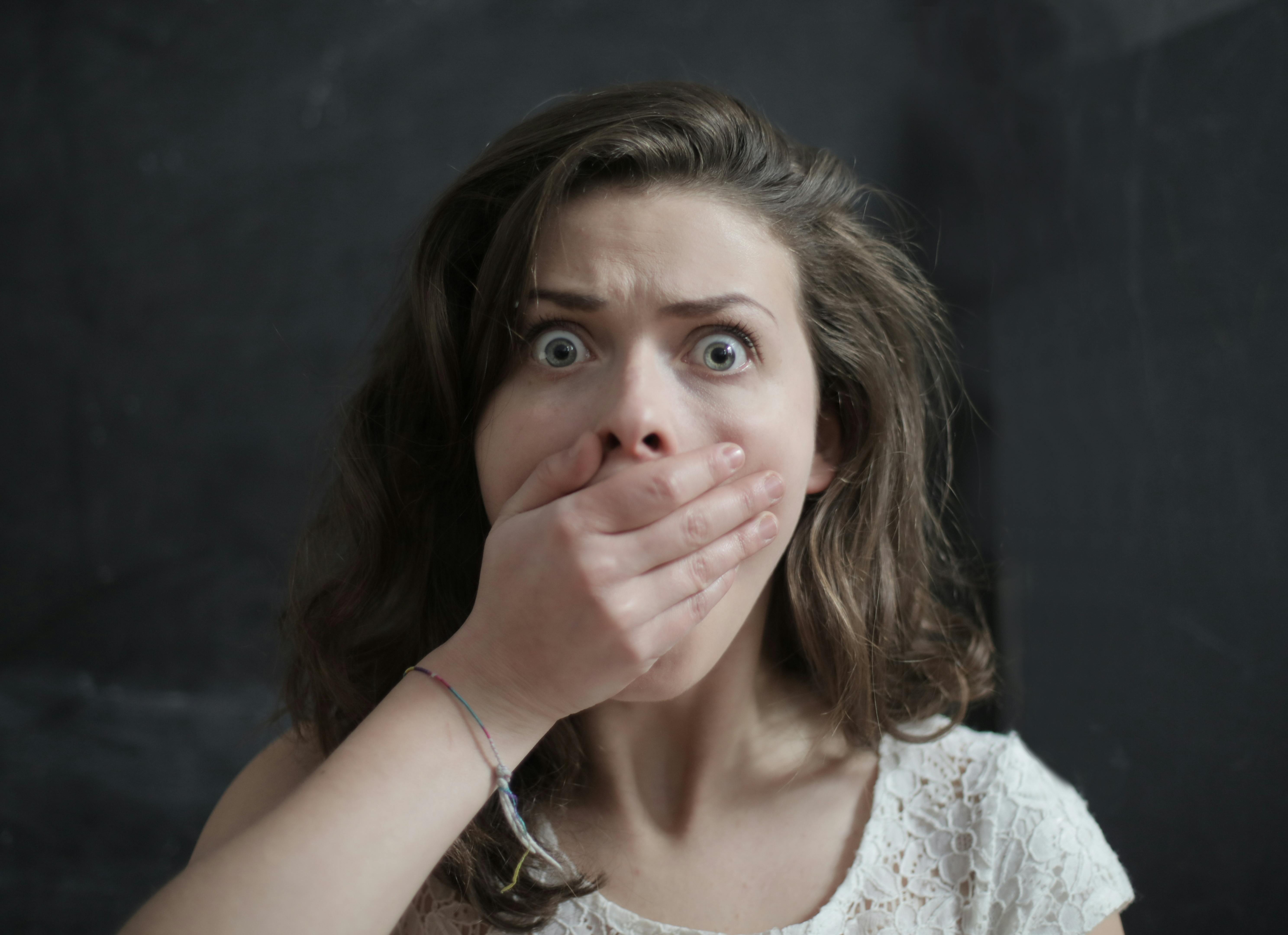 Shocked woman covering her mouth | Source: Pexels