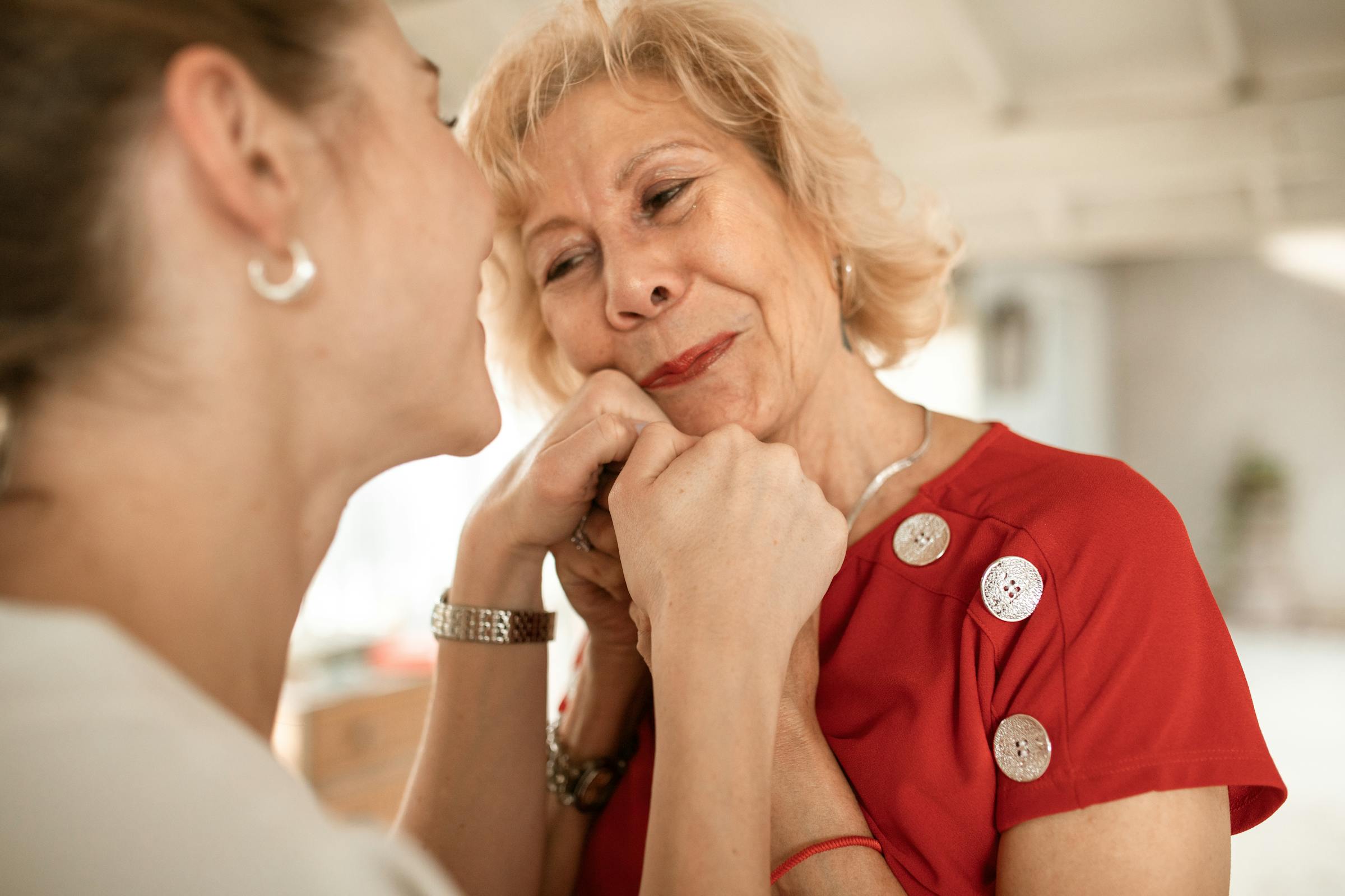 A mother and daughter holding each other and smiling | Source: Pexels