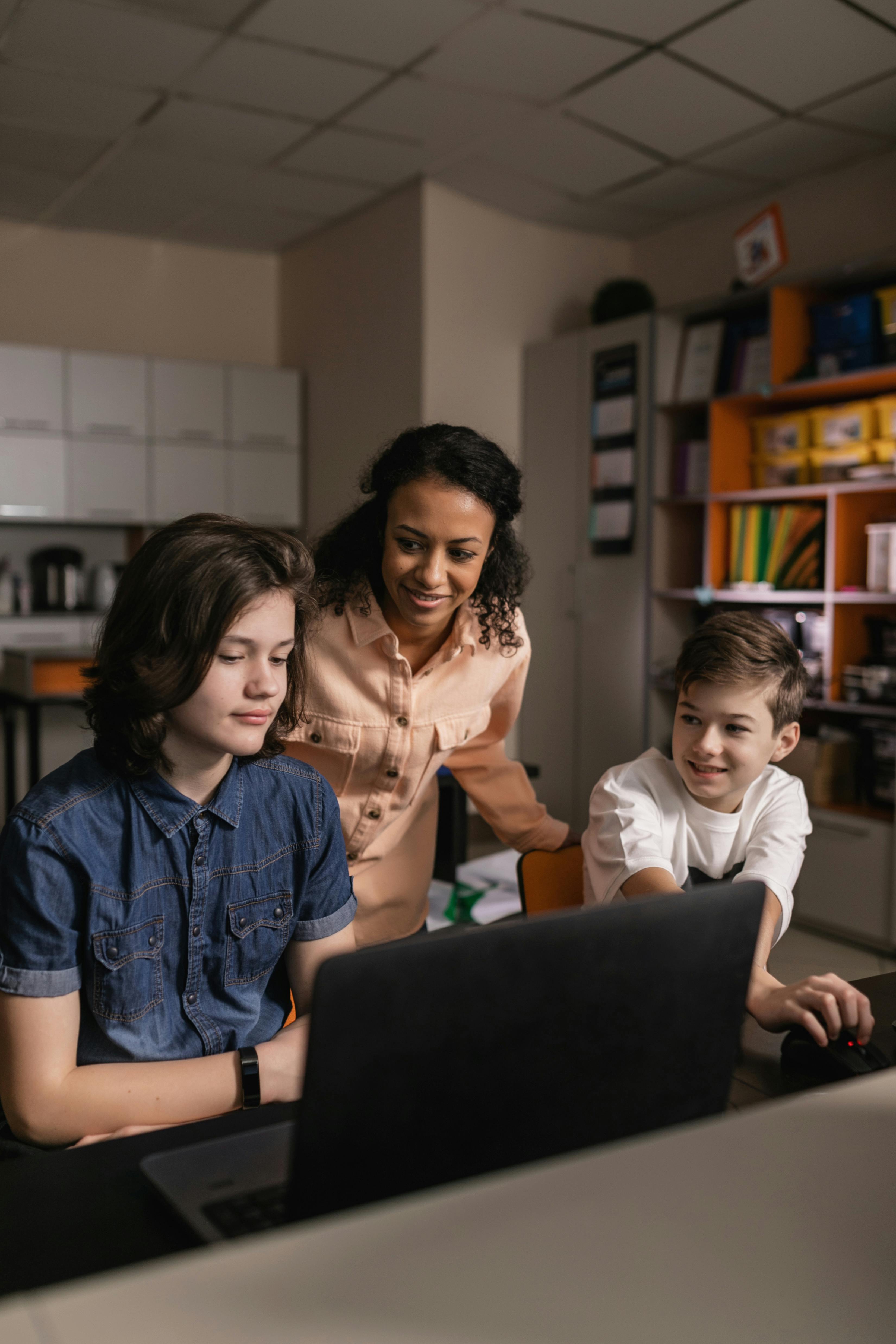 A woman caring for two boys | Source: Pexels