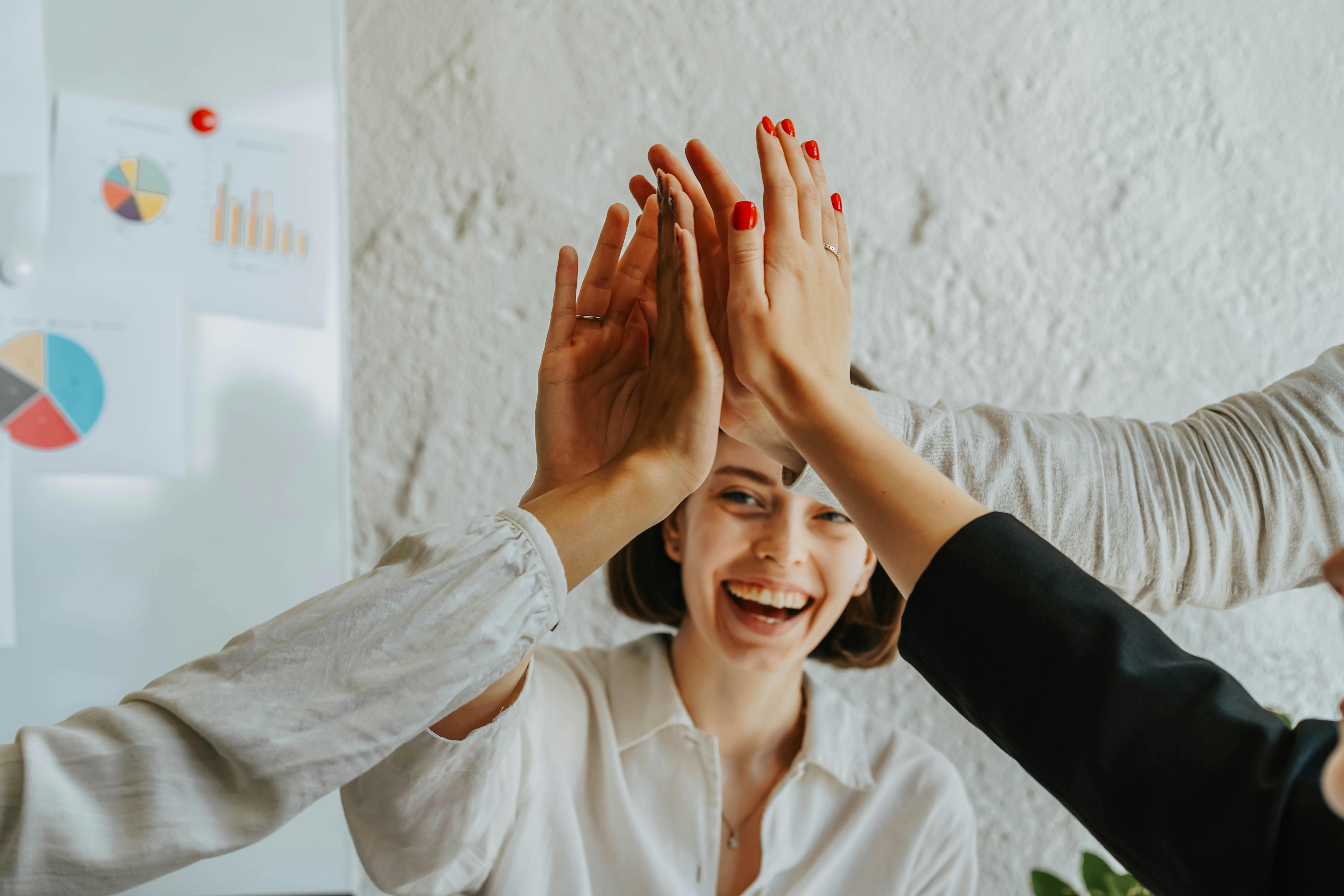 People high-fiving each other | Source: Pexels