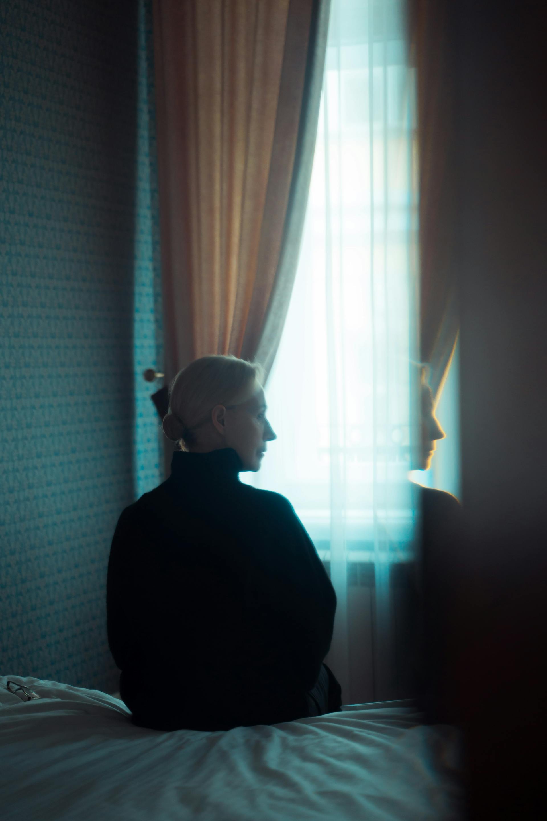 A woman sitting in her bedroom | Source: Pexels
