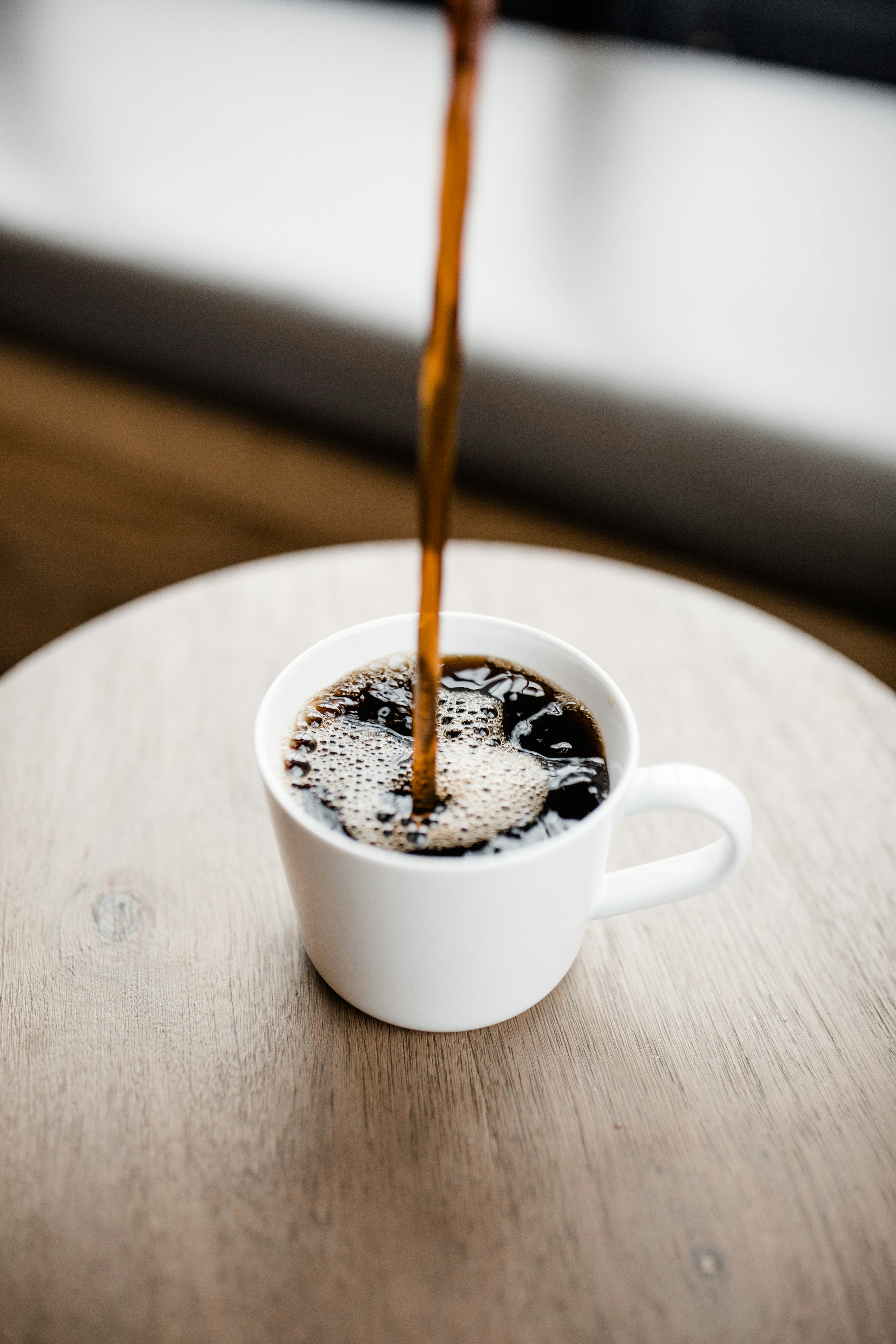 A cup of coffee being poured | Source: Unsplash