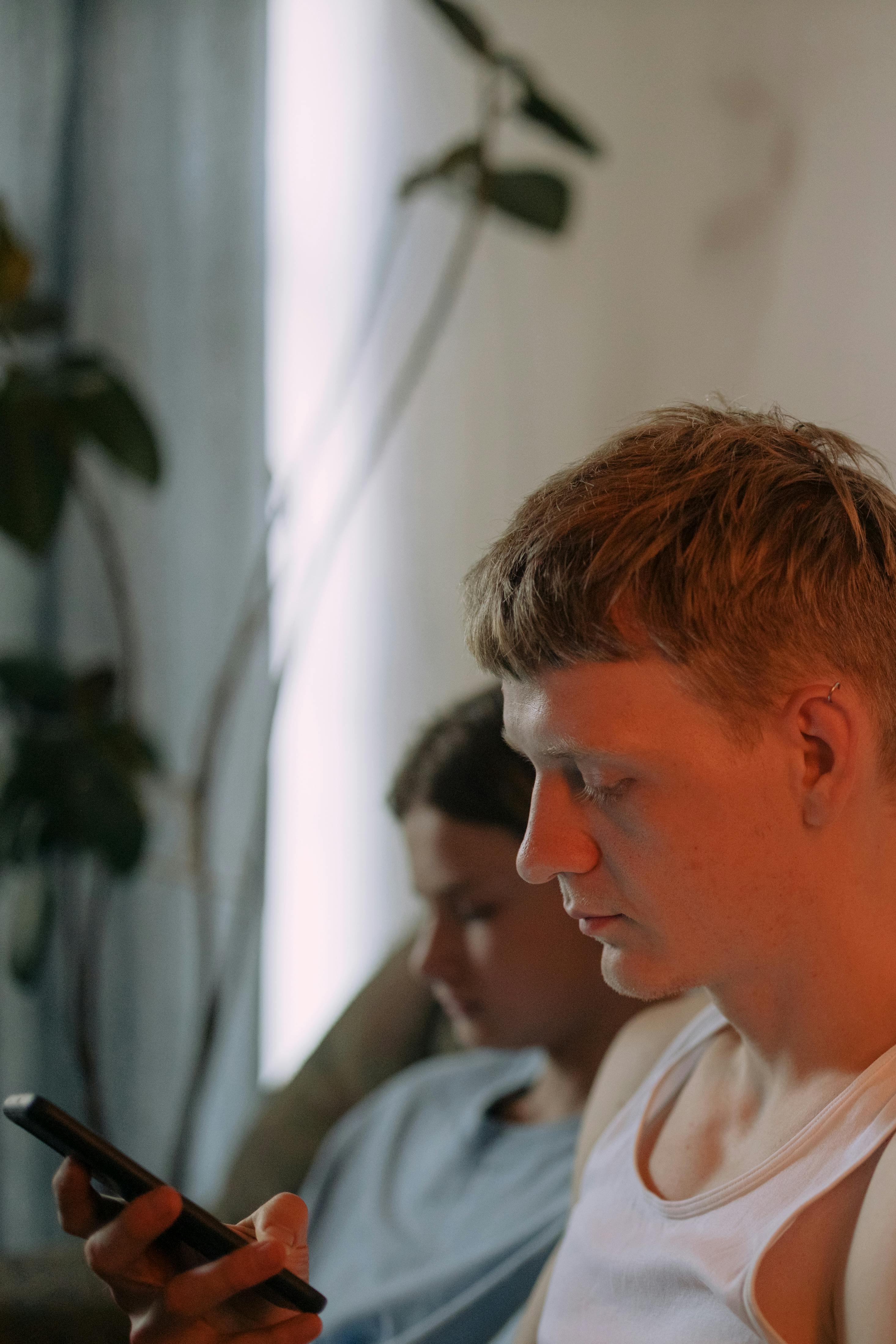 A serious man looking at his phone | Source: Pexels