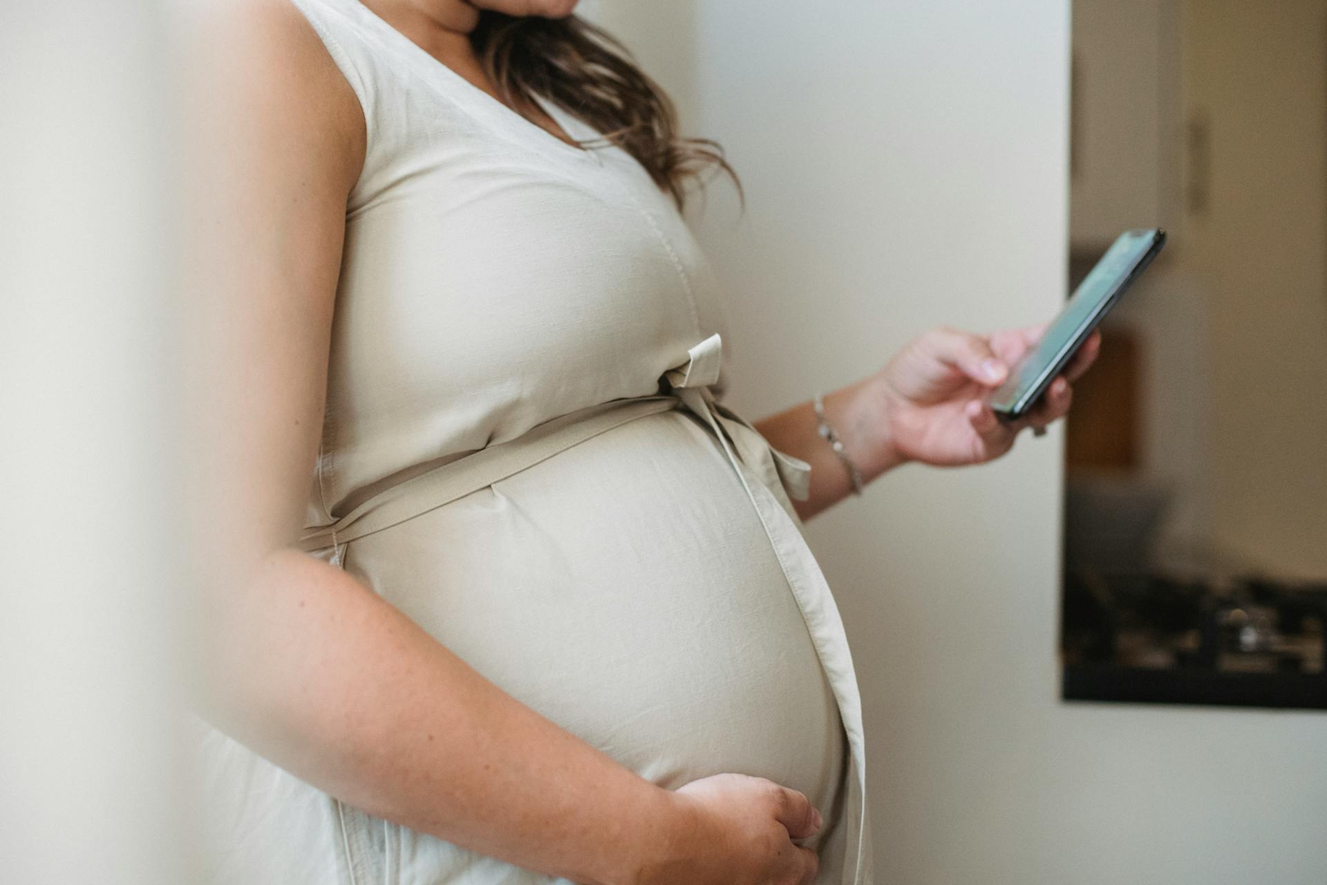 A pregnant woman using her phone | Source: Pexels