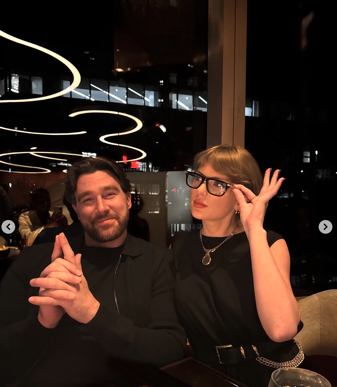 Travis Kelce and Taylor swift pose by a dinner table, posted by the NFL athlete on July 25, 2025. | Source: Instagram/killatrav