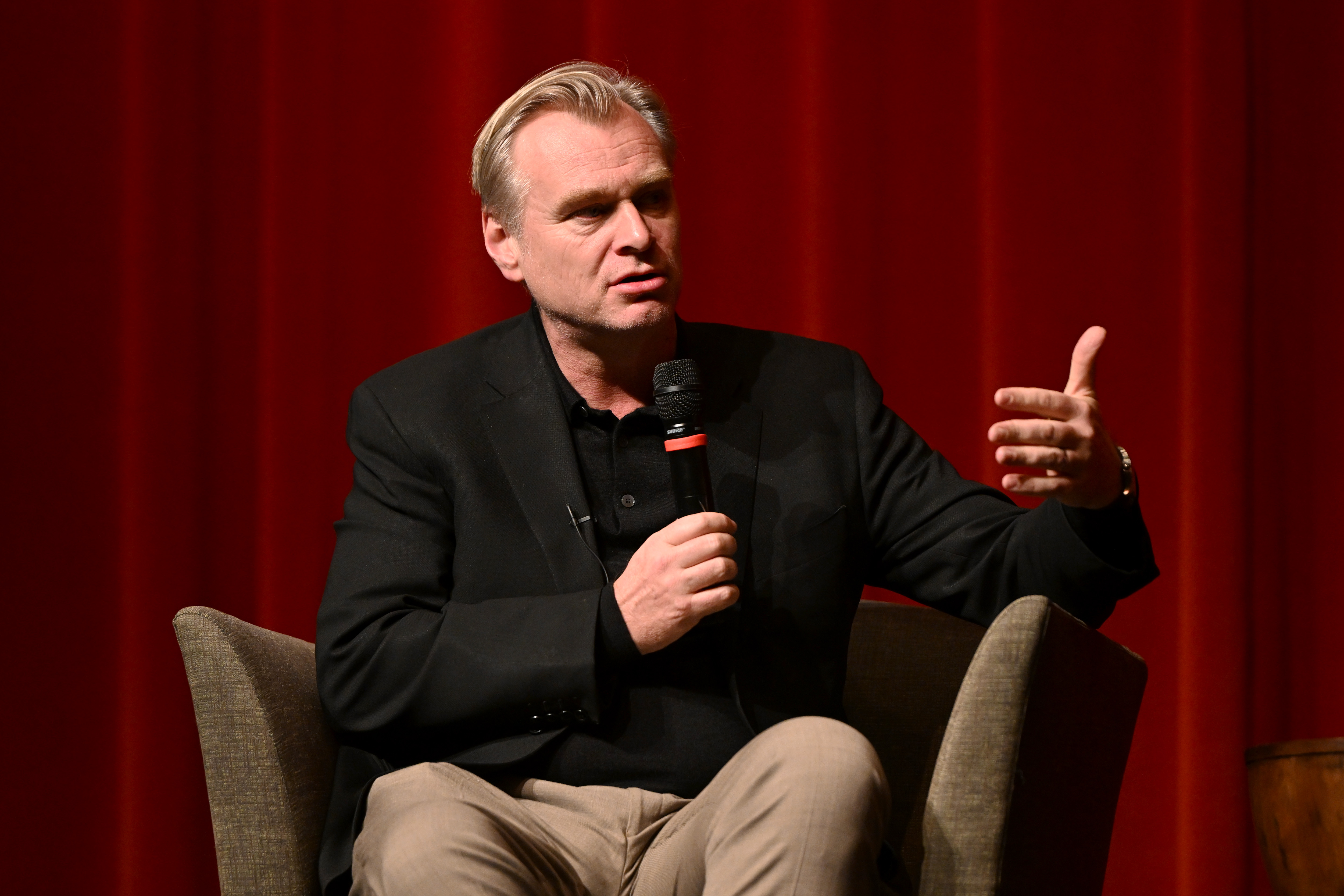Christopher Nolan speaks onstage during a "Gladiator II" conversation with Director Ridley Scott in Los Angeles at the DGA Theater Complex on December 10, 2024, in Los Angeles, California