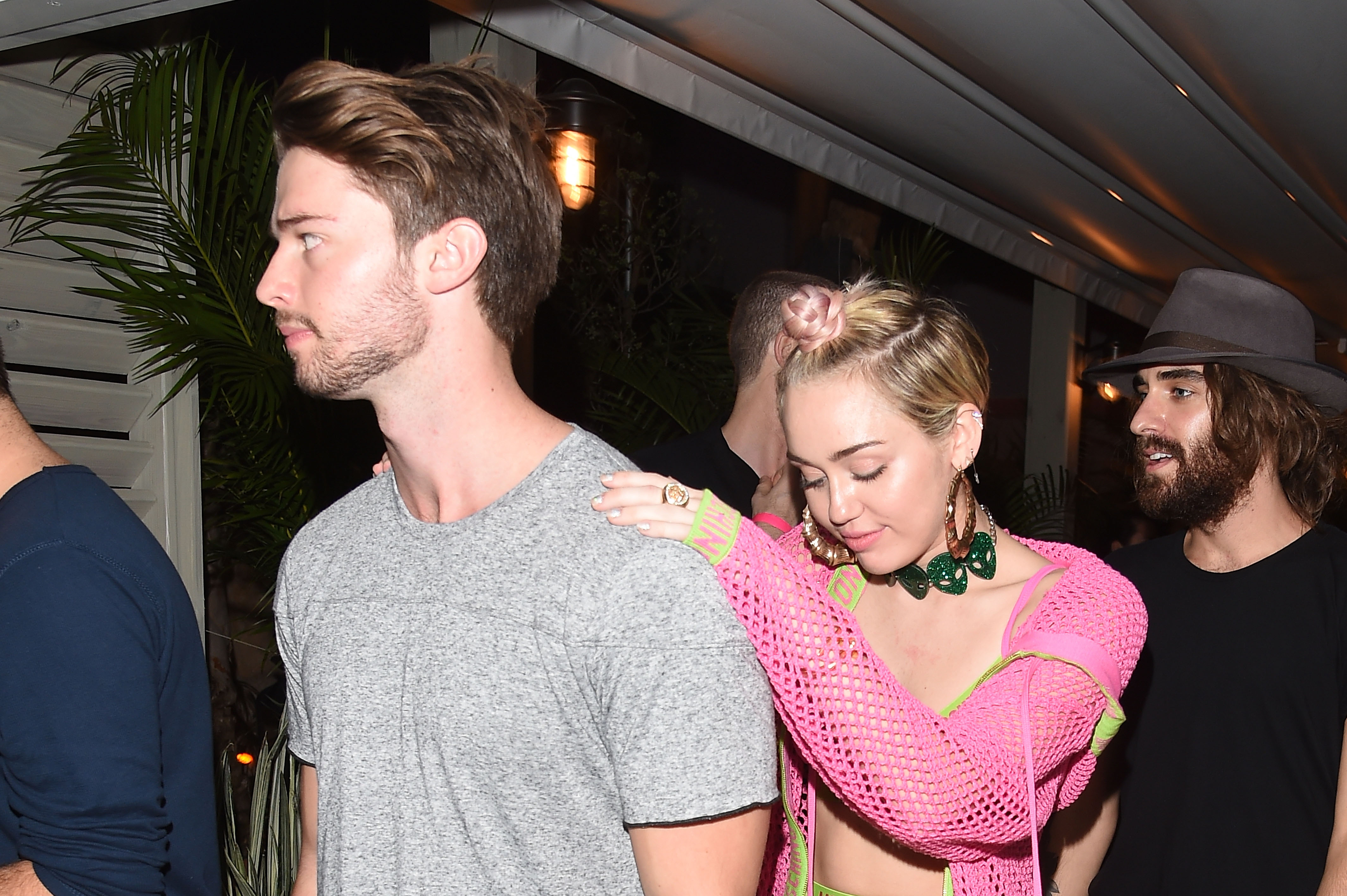 Patrick Schwarzenegger and Miley Cyrus attend Jeremy Scott & Moschino Party with Barbie on December 4, 2014 in Miami Beach, Florida. | Source: Getty Images