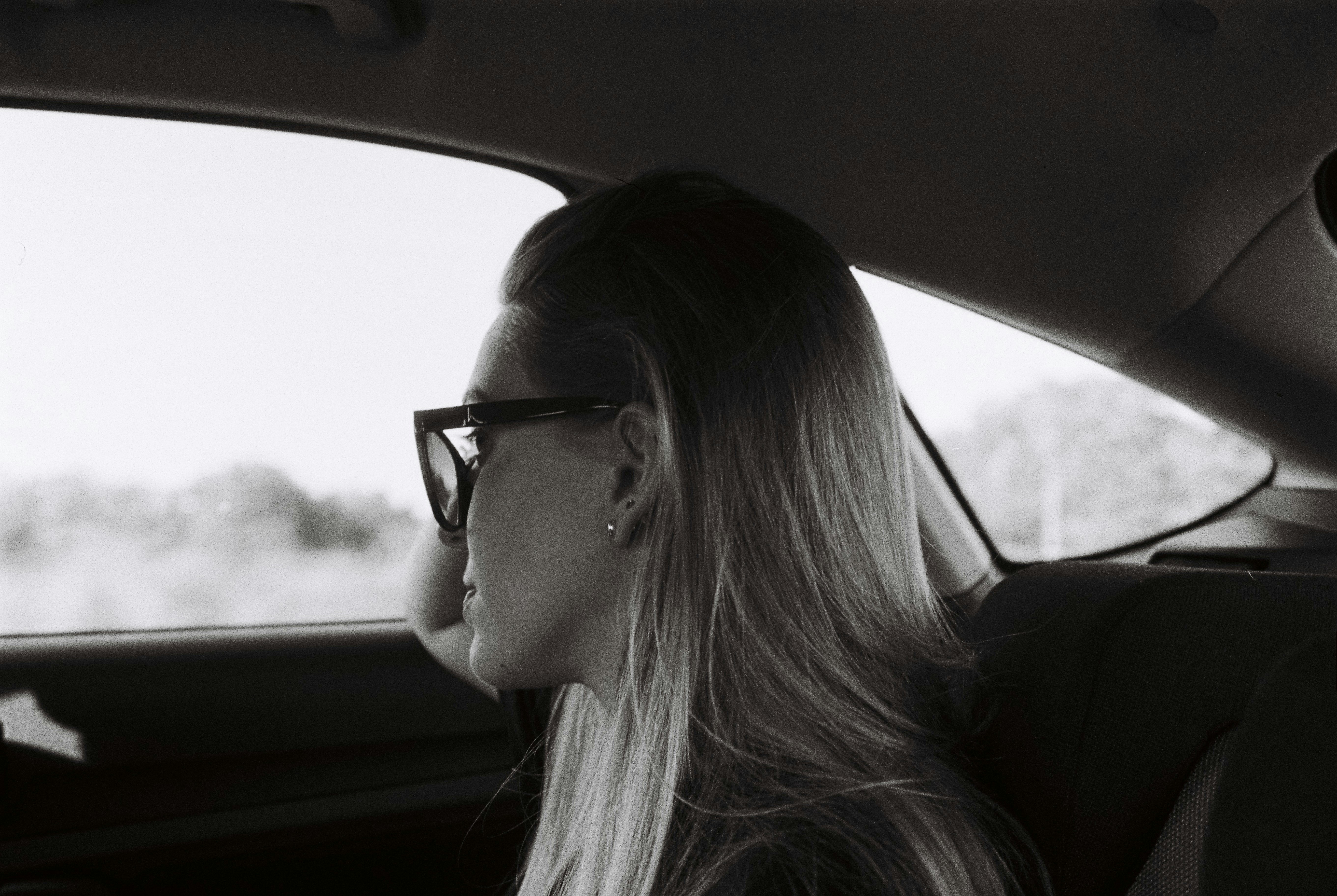 A woman sitting in a car | Source: Unsplash