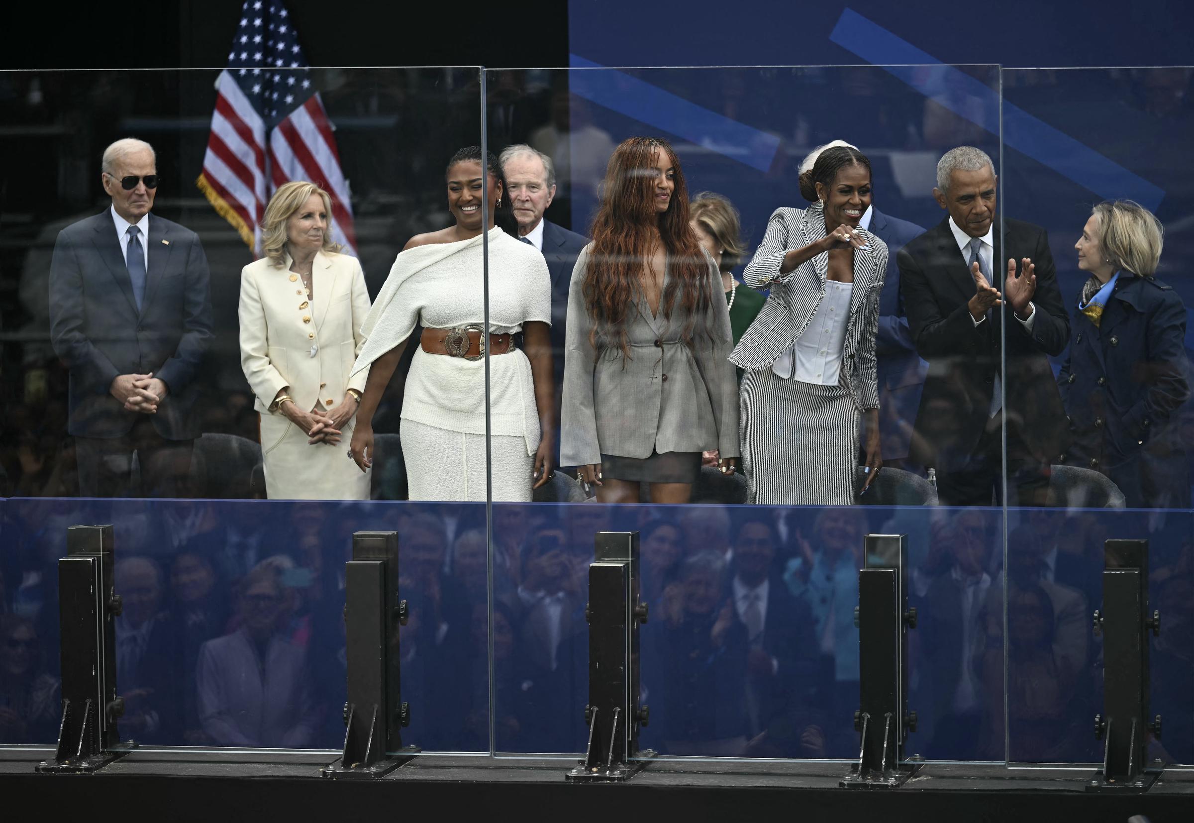 (L-R) Former US president Joe Biden, his wife Jill Biden, Sasha Obama, former US president George W. Bush, Malia Obama, former US first lady Michelle Obama, former US president Barack Obama and former US first lady Hillary Clinton attend the dedication ceremony for the opening of the Barack Obama Presidential Center, in John Lewis Plaza, on June 18, 2026 in Chicago, Illinois. | Source: Getty Images