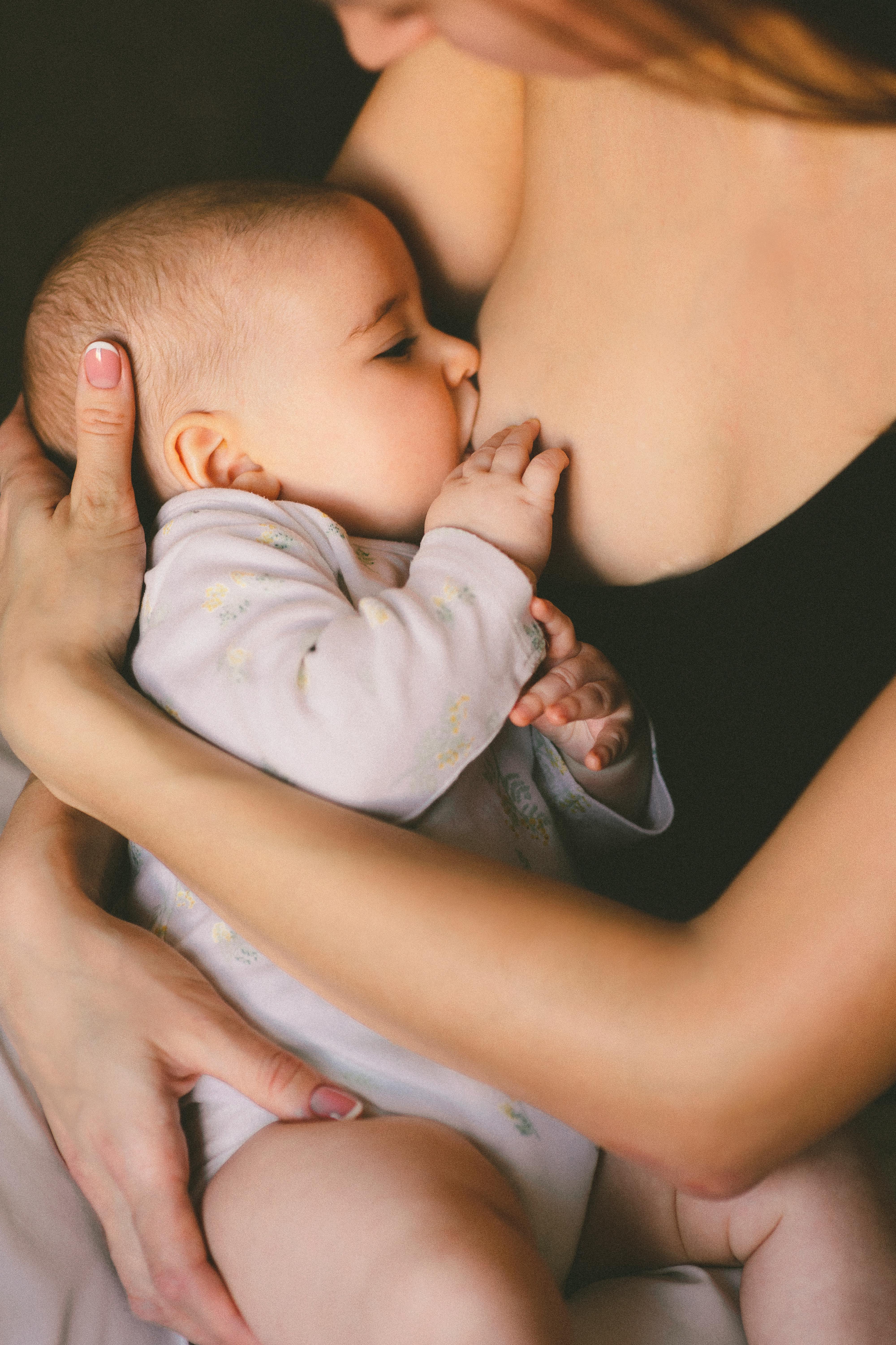 A woman feeding a baby | Source: Pexels