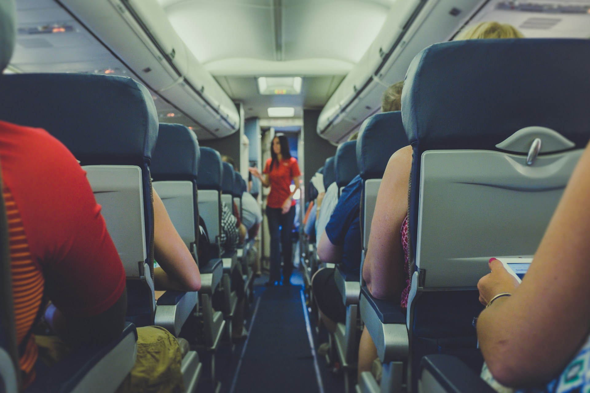 A flight attendant standing in the aisle | Source: Unsplash