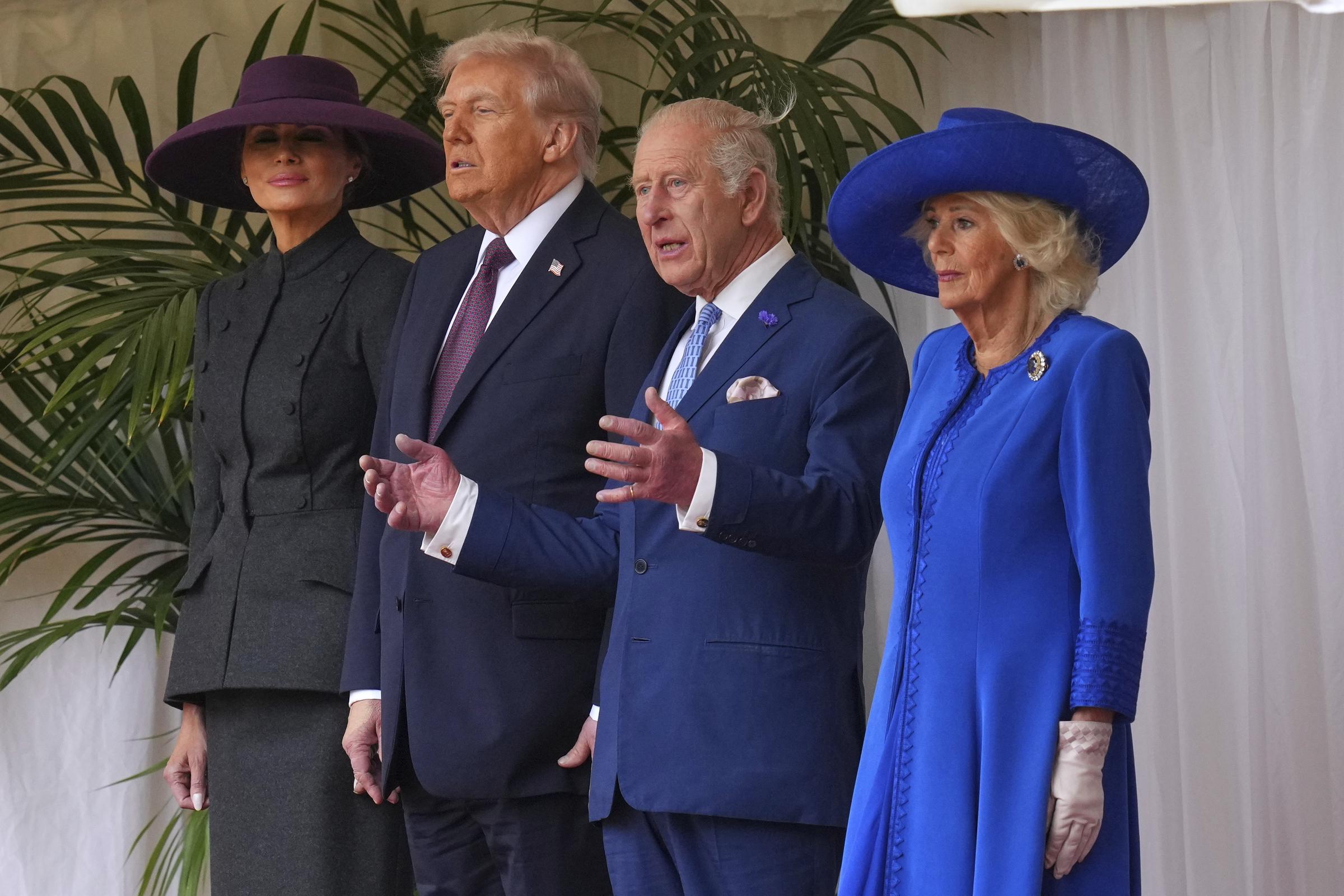 President Donald Trump (2nd L) stands beside King Charles III (2nd R) and Queen Camilla (R) with Melania Trump (L) as they wait to review the Guard of Honour at Windsor Castle on day two of the US President Donald Trump's second state visit to the UK on September 17, 2025, in Windsor, England. | Source: Getty Images