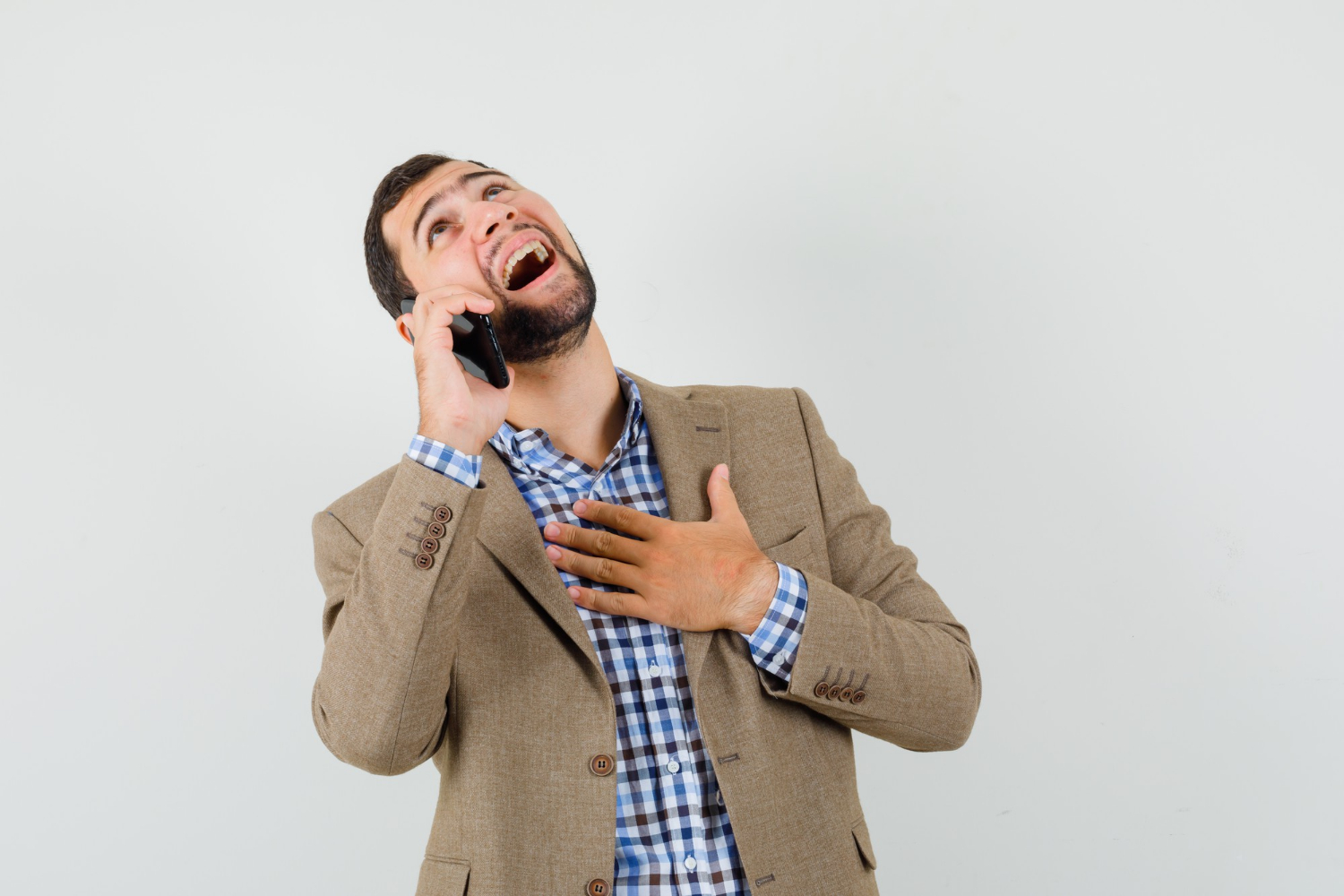 An excited man talking on the phone | Source: Freepik