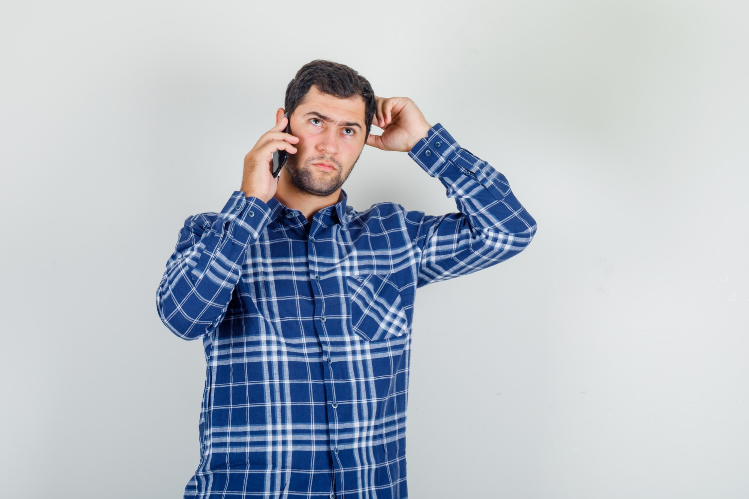 An anxious man talking on the phone | Source: Freepik