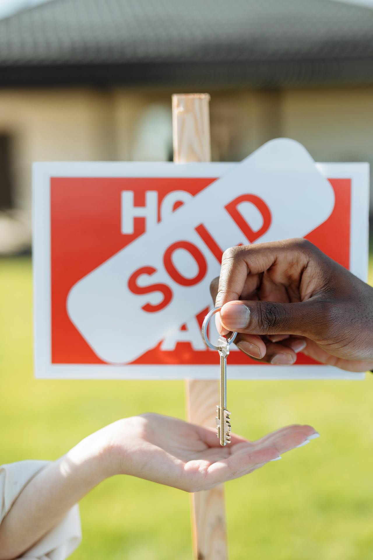 A woman receiving the key to her new house | Source: Pexels