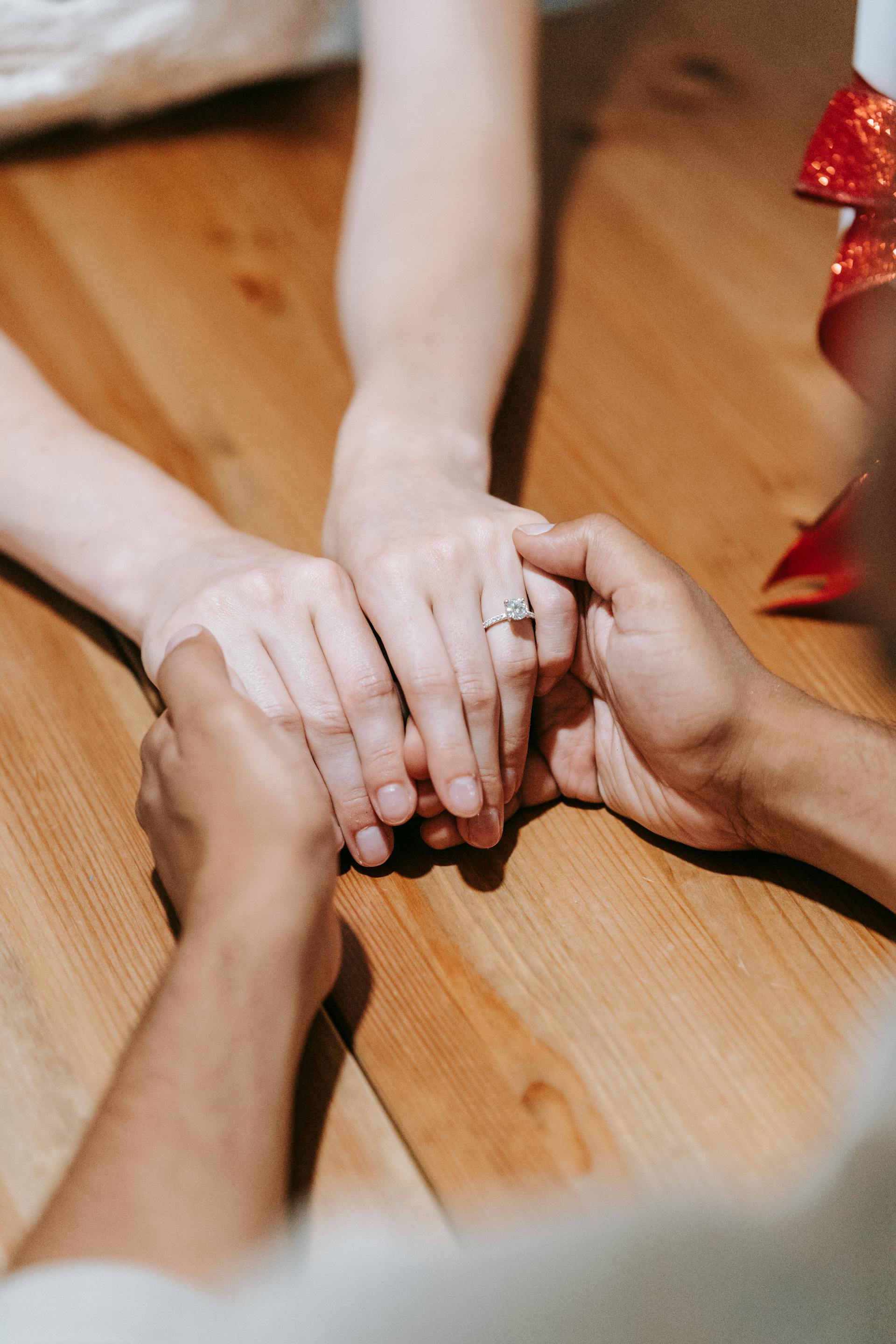 Cropped shot of a man holding his girlfriend's hand | Source: Pexels