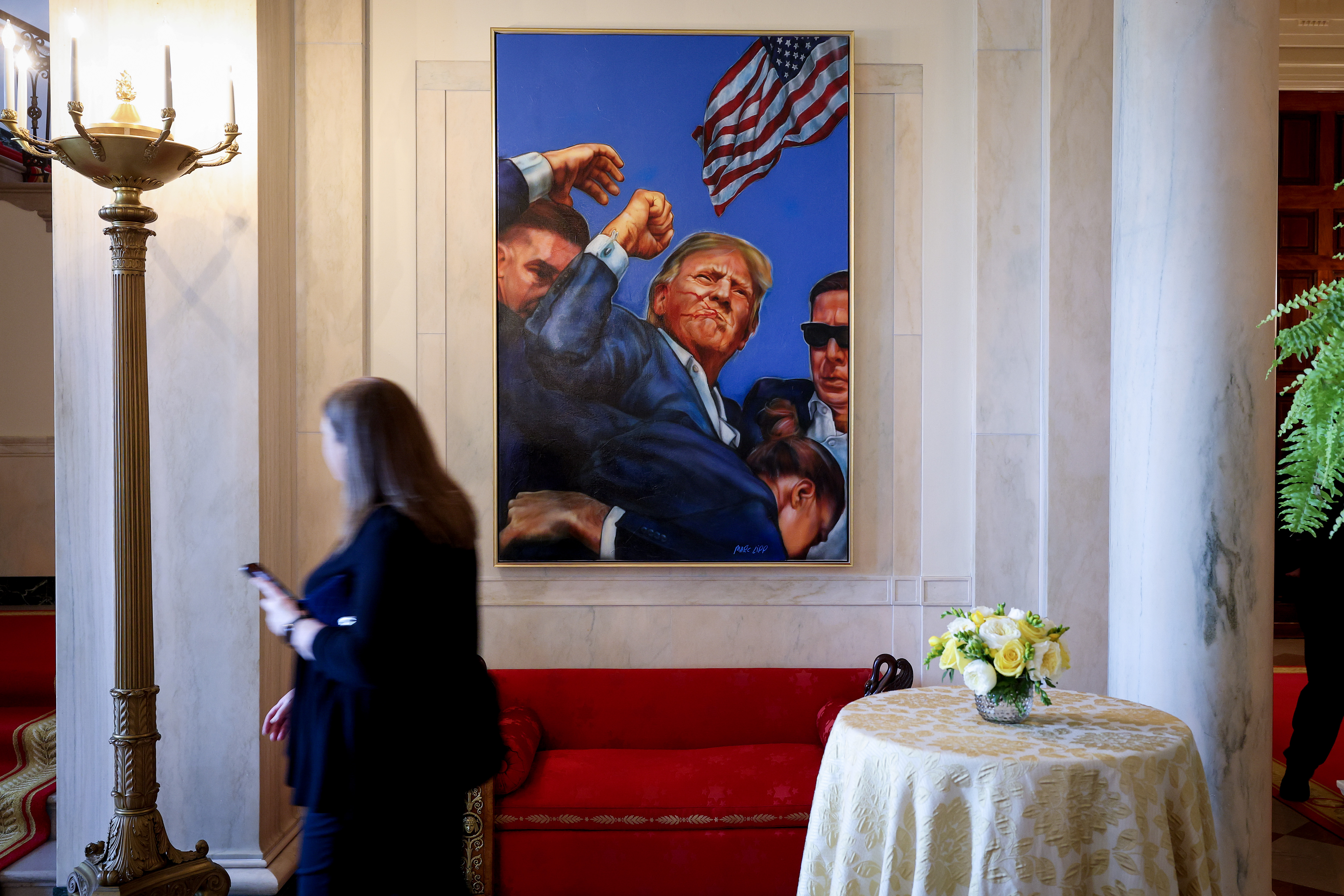 A painting depicting the Associated Press photograph of the aftermath of the assassination attempt on then U.S. Presidential candidate Donald Trump in Butler, Pennsylvania hangs in the Entrance Hall of the White House on April 15, 2025 in Washington, DC. | Source: Getty Images