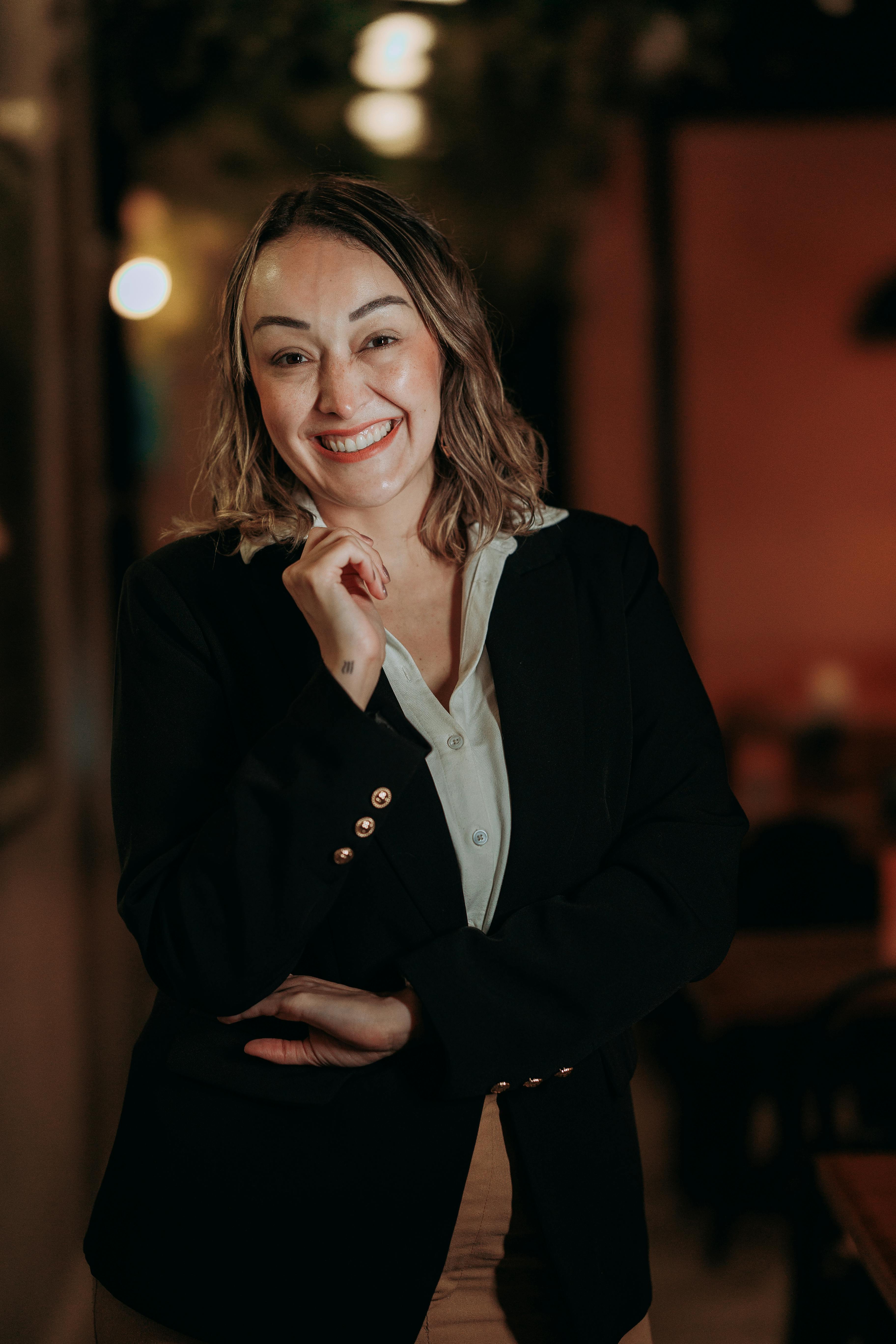 A smiling woman standing in a hotel hallway | Source: Pexels