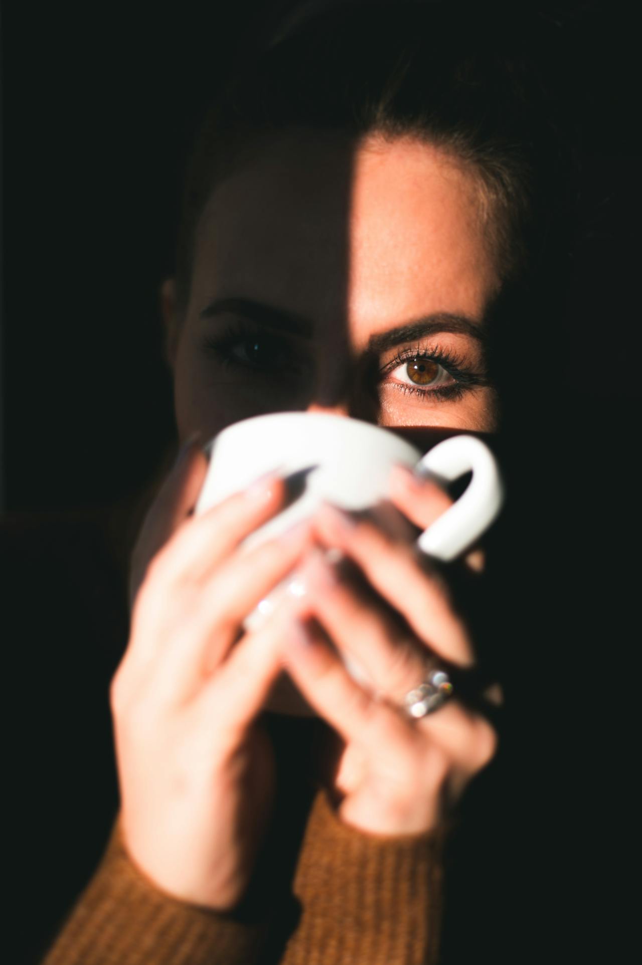 A woman drinking a beverage from a ceramic cup | Source: Pexels