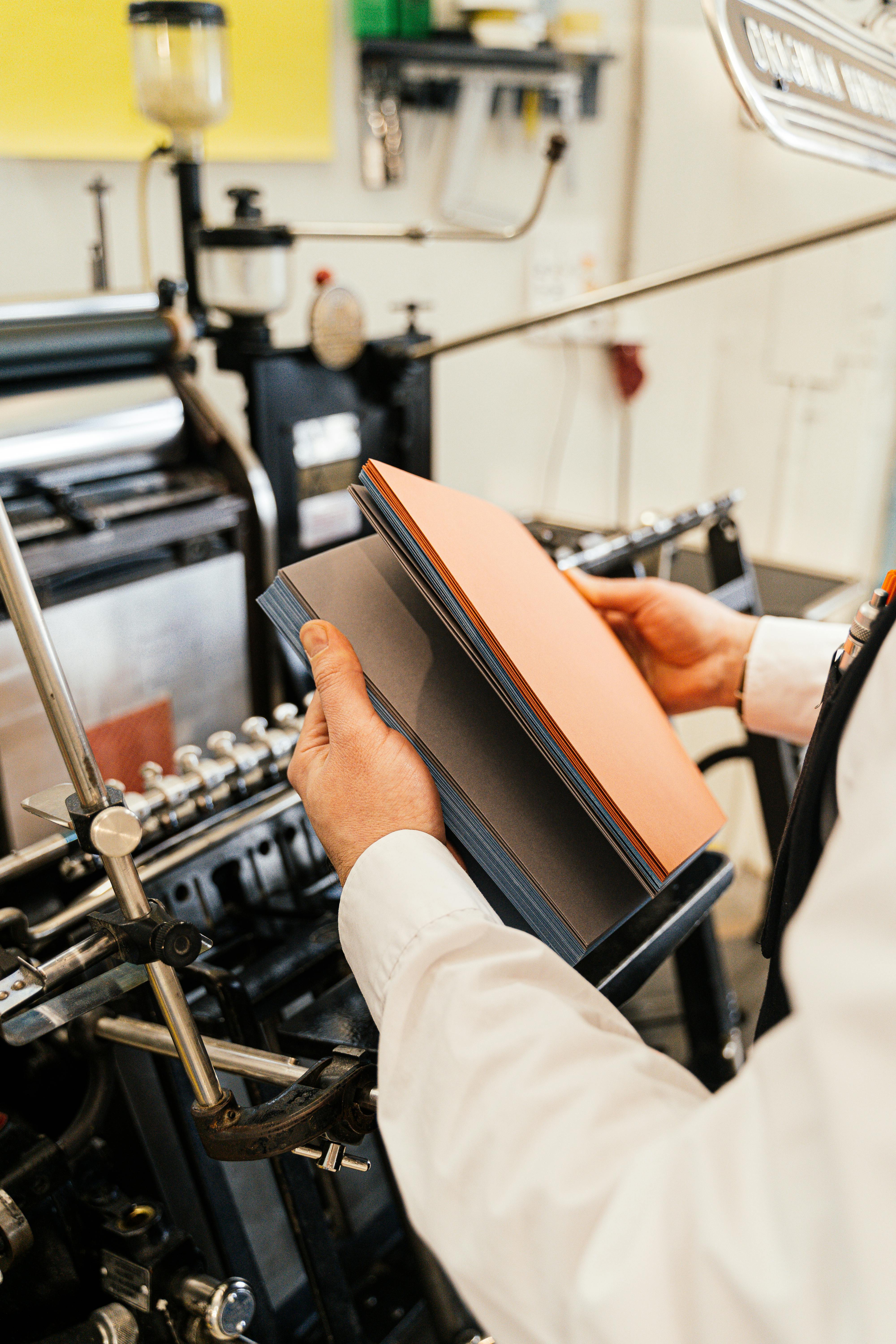 A person holding sheets of paper | Source: Pexels